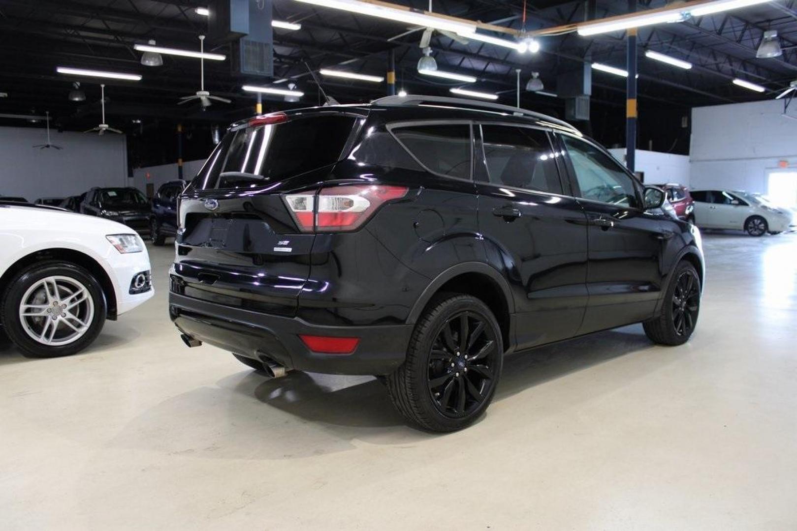 2018 Shadow Black /Charcoal Black Ford Escape SE (1FMCU0GD6JU) with an EcoBoost 2.0L I4 GTDi DOHC Turbocharged VCT engine, Automatic transmission, located at 15300 Midway Rd., Addison, TX, 75001, (972) 702-0011, 32.958321, -96.838074 - 2018 Ford Escape SE<br>Now Available at Midway Auto Group Addison, Texas<br><br>Well-rounded, efficient, and built for everyday versatility, the 2018 Ford Escape SE is the compact SUV that adapts to your lifestyle. With its turbocharged power, smooth ride, and smart interior layout, the Escape is i - Photo#2