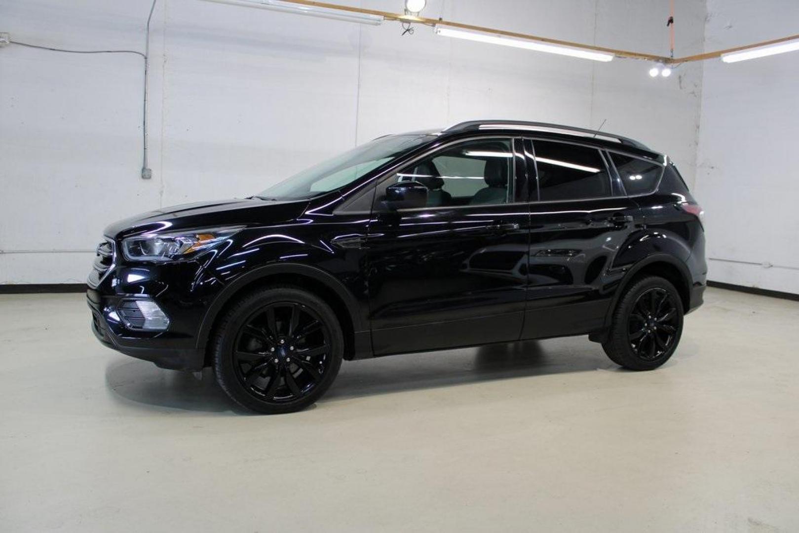 2018 Shadow Black /Charcoal Black Ford Escape SE (1FMCU0GD6JU) with an EcoBoost 2.0L I4 GTDi DOHC Turbocharged VCT engine, Automatic transmission, located at 15300 Midway Rd., Addison, TX, 75001, (972) 702-0011, 32.958321, -96.838074 - 2018 Ford Escape SE<br>Now Available at Midway Auto Group Addison, Texas<br><br>Well-rounded, efficient, and built for everyday versatility, the 2018 Ford Escape SE is the compact SUV that adapts to your lifestyle. With its turbocharged power, smooth ride, and smart interior layout, the Escape is i - Photo#4