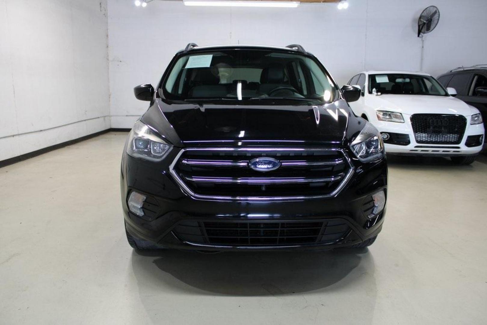 2018 Shadow Black /Charcoal Black Ford Escape SE (1FMCU0GD6JU) with an EcoBoost 2.0L I4 GTDi DOHC Turbocharged VCT engine, Automatic transmission, located at 15300 Midway Rd., Addison, TX, 75001, (972) 702-0011, 32.958321, -96.838074 - 2018 Ford Escape SE<br>Now Available at Midway Auto Group Addison, Texas<br><br>Well-rounded, efficient, and built for everyday versatility, the 2018 Ford Escape SE is the compact SUV that adapts to your lifestyle. With its turbocharged power, smooth ride, and smart interior layout, the Escape is i - Photo#5