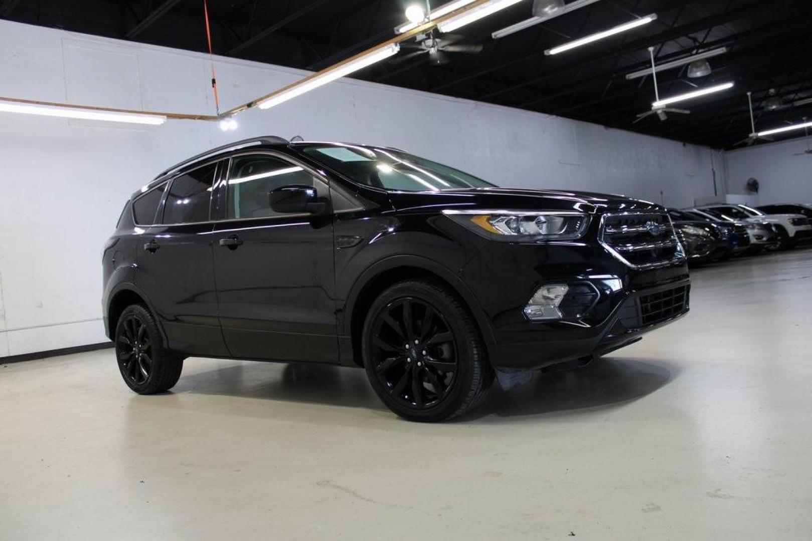 2018 Shadow Black /Charcoal Black Ford Escape SE (1FMCU0GD6JU) with an EcoBoost 2.0L I4 GTDi DOHC Turbocharged VCT engine, Automatic transmission, located at 15300 Midway Rd., Addison, TX, 75001, (972) 702-0011, 32.958321, -96.838074 - 2018 Ford Escape SE<br>Now Available at Midway Auto Group Addison, Texas<br><br>Well-rounded, efficient, and built for everyday versatility, the 2018 Ford Escape SE is the compact SUV that adapts to your lifestyle. With its turbocharged power, smooth ride, and smart interior layout, the Escape is i - Photo#6