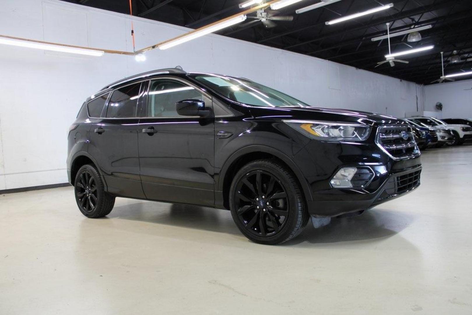 2018 Shadow Black /Charcoal Black Ford Escape SE (1FMCU0GD6JU) with an EcoBoost 2.0L I4 GTDi DOHC Turbocharged VCT engine, Automatic transmission, located at 15300 Midway Rd., Addison, TX, 75001, (972) 702-0011, 32.958321, -96.838074 - 2018 Ford Escape SE<br>Now Available at Midway Auto Group Addison, Texas<br><br>Well-rounded, efficient, and built for everyday versatility, the 2018 Ford Escape SE is the compact SUV that adapts to your lifestyle. With its turbocharged power, smooth ride, and smart interior layout, the Escape is i - Photo#7