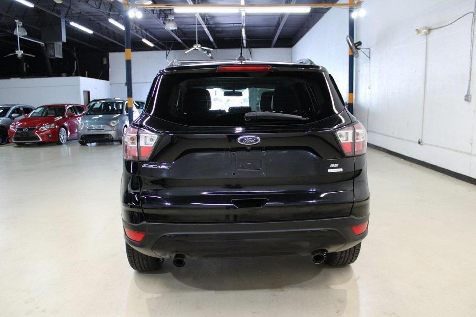 2018 Shadow Black /Charcoal Black Ford Escape SE (1FMCU0GD6JU) with an EcoBoost 2.0L I4 GTDi DOHC Turbocharged VCT engine, Automatic transmission, located at 15300 Midway Rd., Addison, TX, 75001, (972) 702-0011, 32.958321, -96.838074 - 2018 Ford Escape SE<br>Now Available at Midway Auto Group Addison, Texas<br><br>Well-rounded, efficient, and built for everyday versatility, the 2018 Ford Escape SE is the compact SUV that adapts to your lifestyle. With its turbocharged power, smooth ride, and smart interior layout, the Escape is i - Photo#8