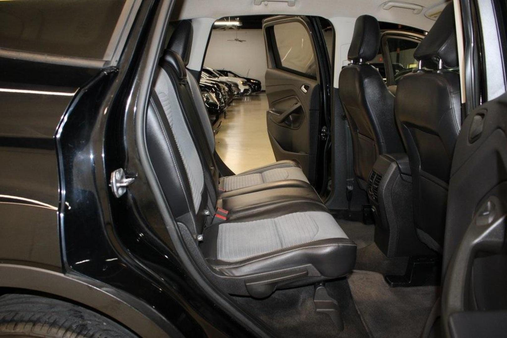 2018 Shadow Black /Charcoal Black Ford Escape SE (1FMCU0GD6JU) with an EcoBoost 2.0L I4 GTDi DOHC Turbocharged VCT engine, Automatic transmission, located at 15300 Midway Rd., Addison, TX, 75001, (972) 702-0011, 32.958321, -96.838074 - 2018 Ford Escape SE<br>Now Available at Midway Auto Group Addison, Texas<br><br>Well-rounded, efficient, and built for everyday versatility, the 2018 Ford Escape SE is the compact SUV that adapts to your lifestyle. With its turbocharged power, smooth ride, and smart interior layout, the Escape is i - Photo#16
