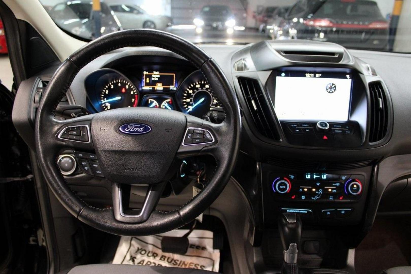 2018 Shadow Black /Charcoal Black Ford Escape SE (1FMCU0GD6JU) with an EcoBoost 2.0L I4 GTDi DOHC Turbocharged VCT engine, Automatic transmission, located at 15300 Midway Rd., Addison, TX, 75001, (972) 702-0011, 32.958321, -96.838074 - 2018 Ford Escape SE<br>Now Available at Midway Auto Group Addison, Texas<br><br>Well-rounded, efficient, and built for everyday versatility, the 2018 Ford Escape SE is the compact SUV that adapts to your lifestyle. With its turbocharged power, smooth ride, and smart interior layout, the Escape is i - Photo#18