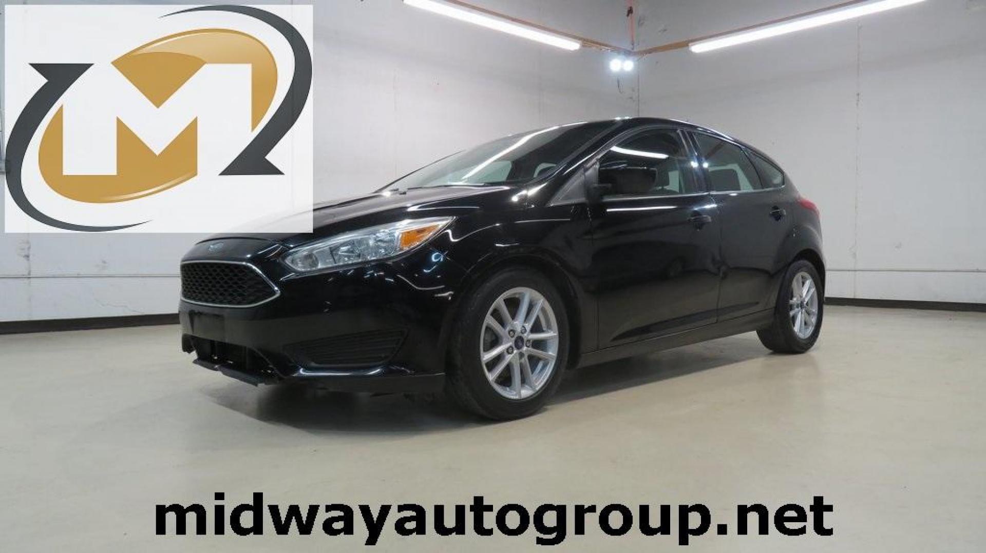 2018 Shadow Black /Charcoal Black Ford Focus SE (1FADP3K28JL) with an 2.0L I4 DGI Ti-VCT engine, Automatic transmission, located at 15300 Midway Rd., Addison, TX, 75001, (972) 702-0011, 32.958321, -96.838074 - 2018 Ford Focus SE Hatchback<br>Now Available at Midway Auto Group Addison, Texas<br><br>The 2018 Ford Focus SE Hatchback combines practicality, efficiency, and style, making it the ideal choice for daily commutes and weekend getaways alike. With its sporty handling, comfortable interior, and advan - Photo#0
