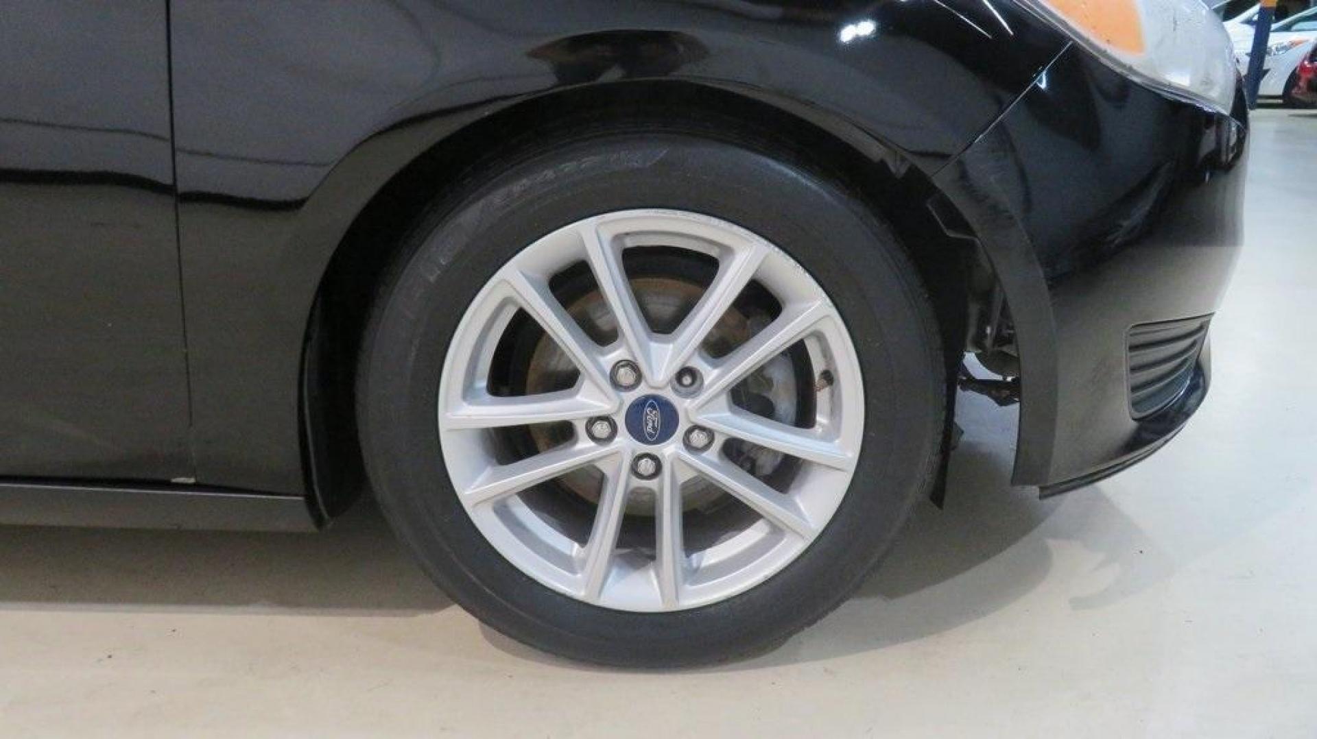 2018 Shadow Black /Charcoal Black Ford Focus SE (1FADP3K28JL) with an 2.0L I4 DGI Ti-VCT engine, Automatic transmission, located at 15300 Midway Rd., Addison, TX, 75001, (972) 702-0011, 32.958321, -96.838074 - 2018 Ford Focus SE Hatchback<br>Now Available at Midway Auto Group Addison, Texas<br><br>The 2018 Ford Focus SE Hatchback combines practicality, efficiency, and style, making it the ideal choice for daily commutes and weekend getaways alike. With its sporty handling, comfortable interior, and advan - Photo#12