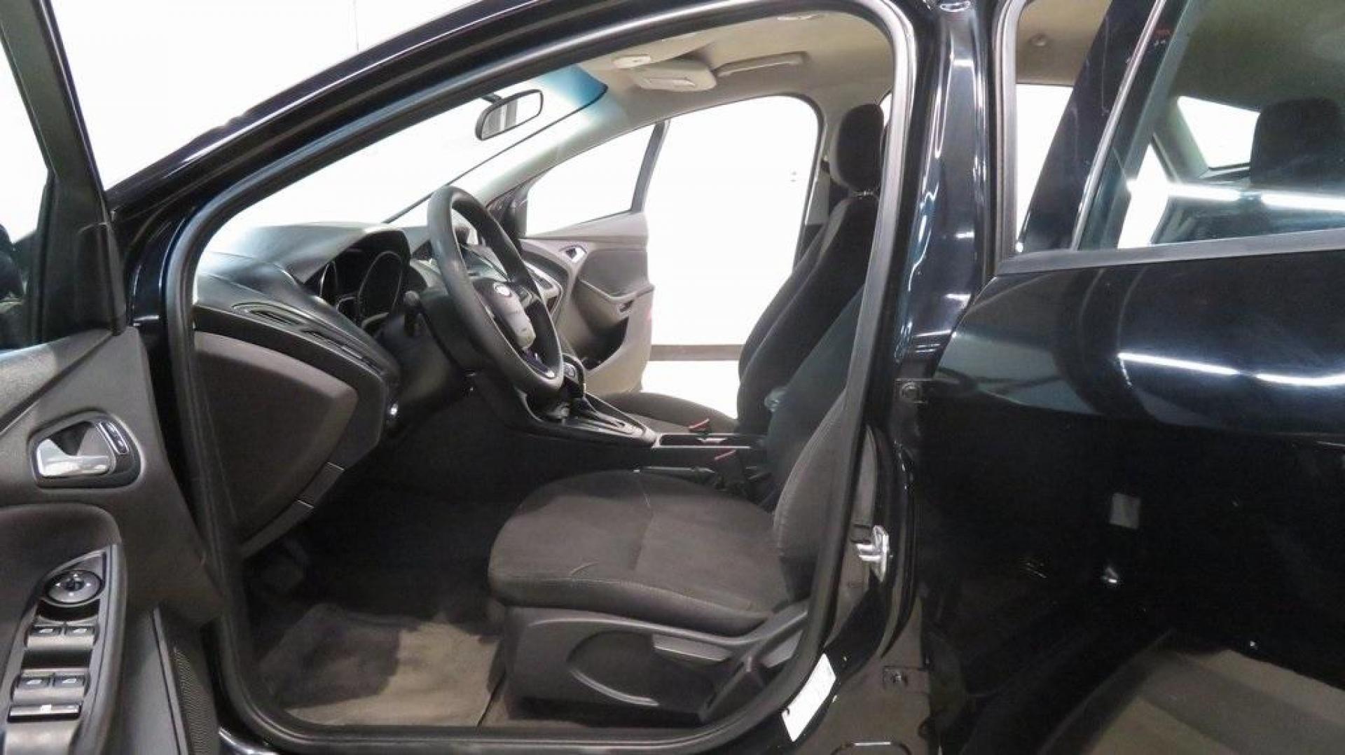 2018 Shadow Black /Charcoal Black Ford Focus SE (1FADP3K28JL) with an 2.0L I4 DGI Ti-VCT engine, Automatic transmission, located at 15300 Midway Rd., Addison, TX, 75001, (972) 702-0011, 32.958321, -96.838074 - 2018 Ford Focus SE Hatchback<br>Now Available at Midway Auto Group Addison, Texas<br><br>The 2018 Ford Focus SE Hatchback combines practicality, efficiency, and style, making it the ideal choice for daily commutes and weekend getaways alike. With its sporty handling, comfortable interior, and advan - Photo#13