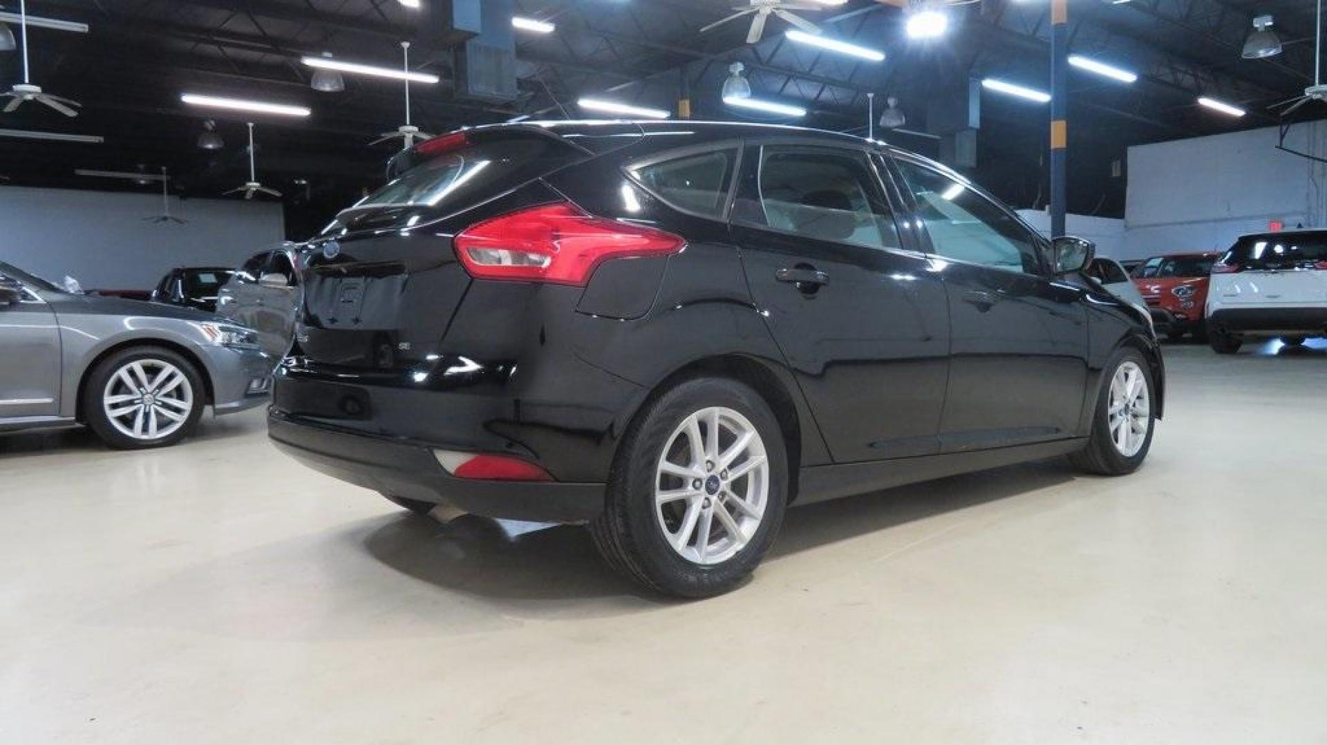 2018 Shadow Black /Charcoal Black Ford Focus SE (1FADP3K28JL) with an 2.0L I4 DGI Ti-VCT engine, Automatic transmission, located at 15300 Midway Rd., Addison, TX, 75001, (972) 702-0011, 32.958321, -96.838074 - 2018 Ford Focus SE Hatchback<br>Now Available at Midway Auto Group Addison, Texas<br><br>The 2018 Ford Focus SE Hatchback combines practicality, efficiency, and style, making it the ideal choice for daily commutes and weekend getaways alike. With its sporty handling, comfortable interior, and advan - Photo#2