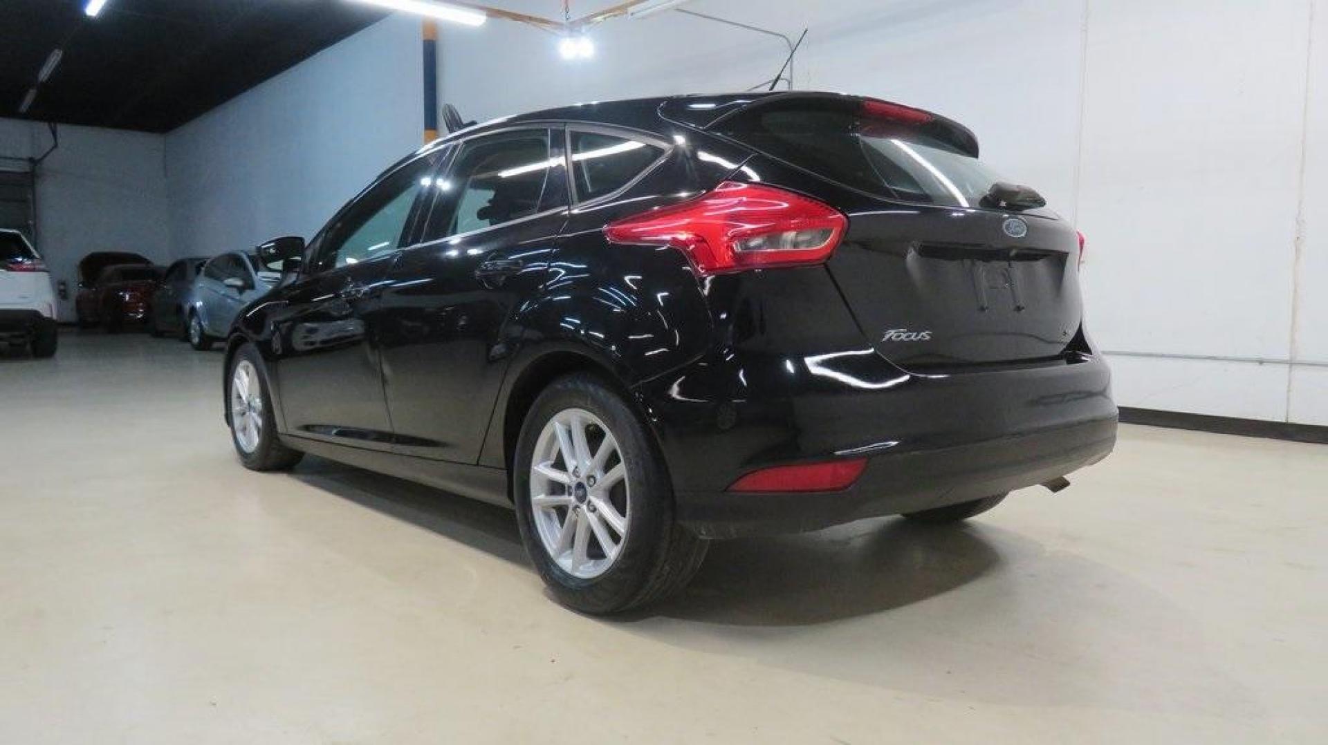 2018 Shadow Black /Charcoal Black Ford Focus SE (1FADP3K28JL) with an 2.0L I4 DGI Ti-VCT engine, Automatic transmission, located at 15300 Midway Rd., Addison, TX, 75001, (972) 702-0011, 32.958321, -96.838074 - 2018 Ford Focus SE Hatchback<br>Now Available at Midway Auto Group Addison, Texas<br><br>The 2018 Ford Focus SE Hatchback combines practicality, efficiency, and style, making it the ideal choice for daily commutes and weekend getaways alike. With its sporty handling, comfortable interior, and advan - Photo#3