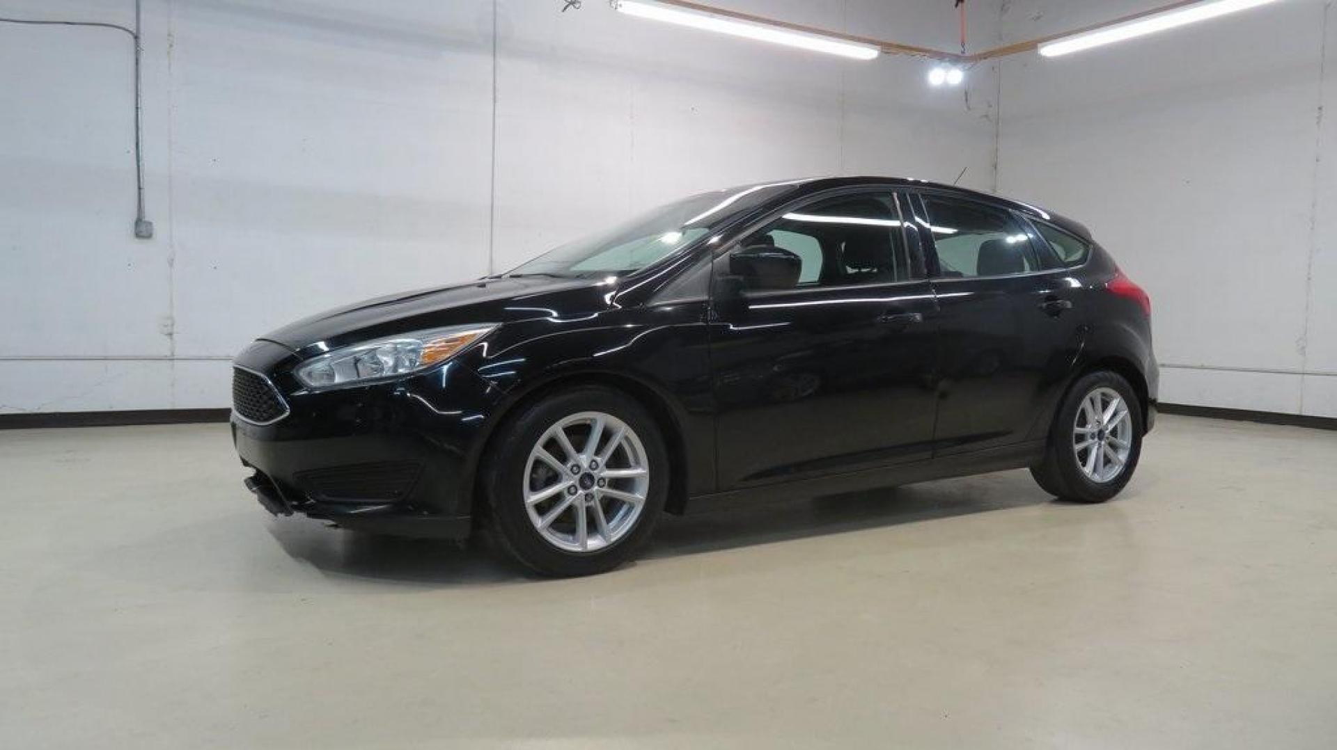 2018 Shadow Black /Charcoal Black Ford Focus SE (1FADP3K28JL) with an 2.0L I4 DGI Ti-VCT engine, Automatic transmission, located at 15300 Midway Rd., Addison, TX, 75001, (972) 702-0011, 32.958321, -96.838074 - 2018 Ford Focus SE Hatchback<br>Now Available at Midway Auto Group Addison, Texas<br><br>The 2018 Ford Focus SE Hatchback combines practicality, efficiency, and style, making it the ideal choice for daily commutes and weekend getaways alike. With its sporty handling, comfortable interior, and advan - Photo#4