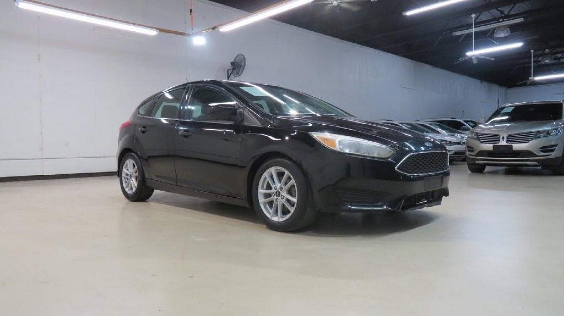 2018 Shadow Black /Charcoal Black Ford Focus SE (1FADP3K28JL) with an 2.0L I4 DGI Ti-VCT engine, Automatic transmission, located at 15300 Midway Rd., Addison, TX, 75001, (972) 702-0011, 32.958321, -96.838074 - 2018 Ford Focus SE Hatchback<br>Now Available at Midway Auto Group Addison, Texas<br><br>The 2018 Ford Focus SE Hatchback combines practicality, efficiency, and style, making it the ideal choice for daily commutes and weekend getaways alike. With its sporty handling, comfortable interior, and advan - Photo#6