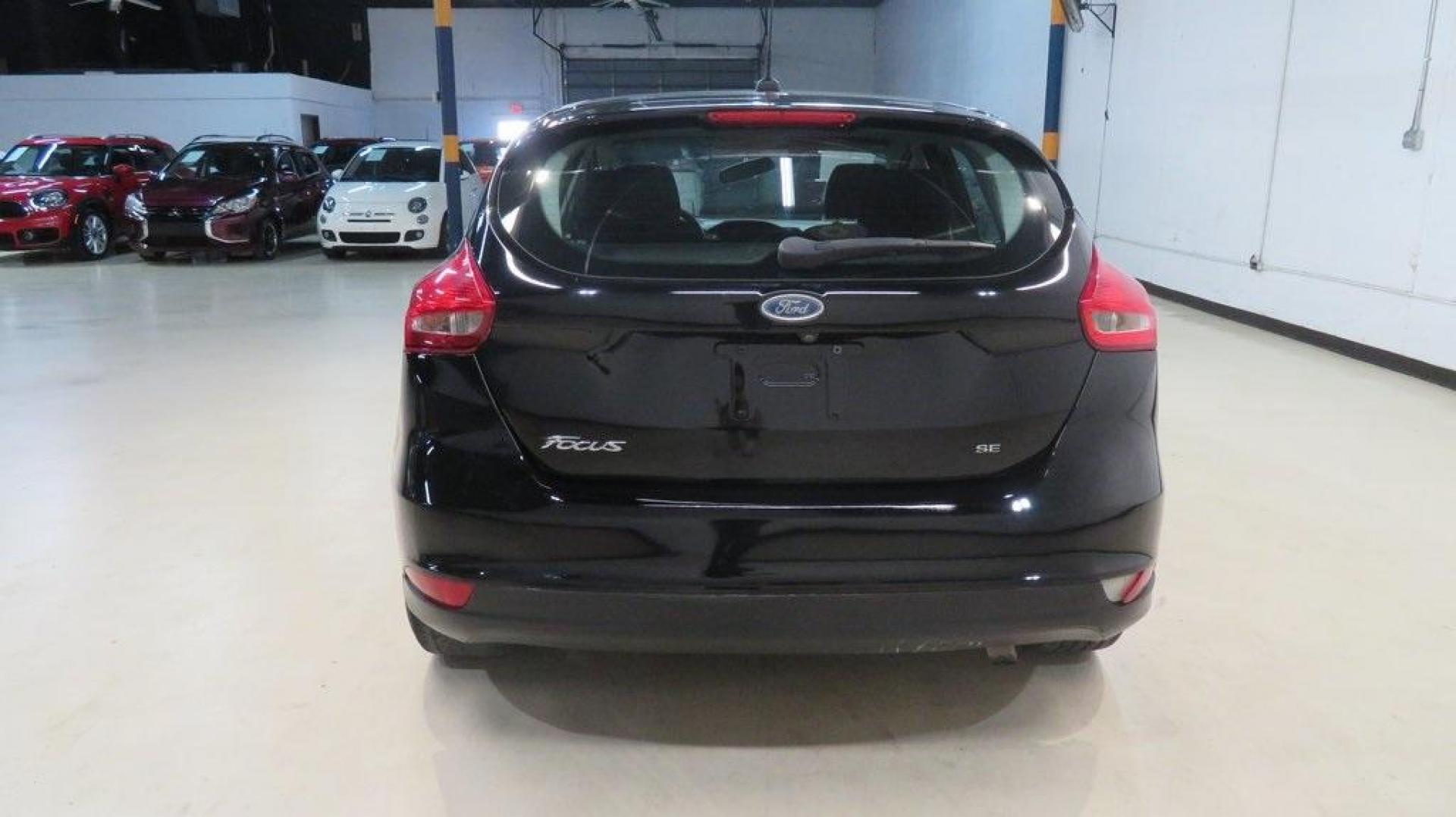 2018 Shadow Black /Charcoal Black Ford Focus SE (1FADP3K28JL) with an 2.0L I4 DGI Ti-VCT engine, Automatic transmission, located at 15300 Midway Rd., Addison, TX, 75001, (972) 702-0011, 32.958321, -96.838074 - 2018 Ford Focus SE Hatchback<br>Now Available at Midway Auto Group Addison, Texas<br><br>The 2018 Ford Focus SE Hatchback combines practicality, efficiency, and style, making it the ideal choice for daily commutes and weekend getaways alike. With its sporty handling, comfortable interior, and advan - Photo#8