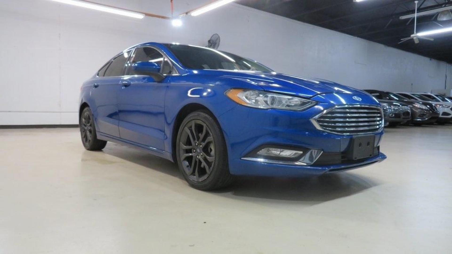 2018 Lightning Blue /Ebony Ford Fusion SE (3FA6P0HDXJR) with an 1.5L EcoBoost engine, Automatic transmission, located at 15300 Midway Rd., Addison, TX, 75001, (972) 702-0011, 32.958321, -96.838074 - 2018 Ford Fusion SE<br>Available now at Midway Auto Group Addison, Texas<br><br>Discover sophisticated styling and impressive performance in the 2018 Ford Fusion SE at Midway Auto Group. Designed for comfort and convenience, this sedan is perfect for daily commutes, weekend adventures, and everythi - Photo#1