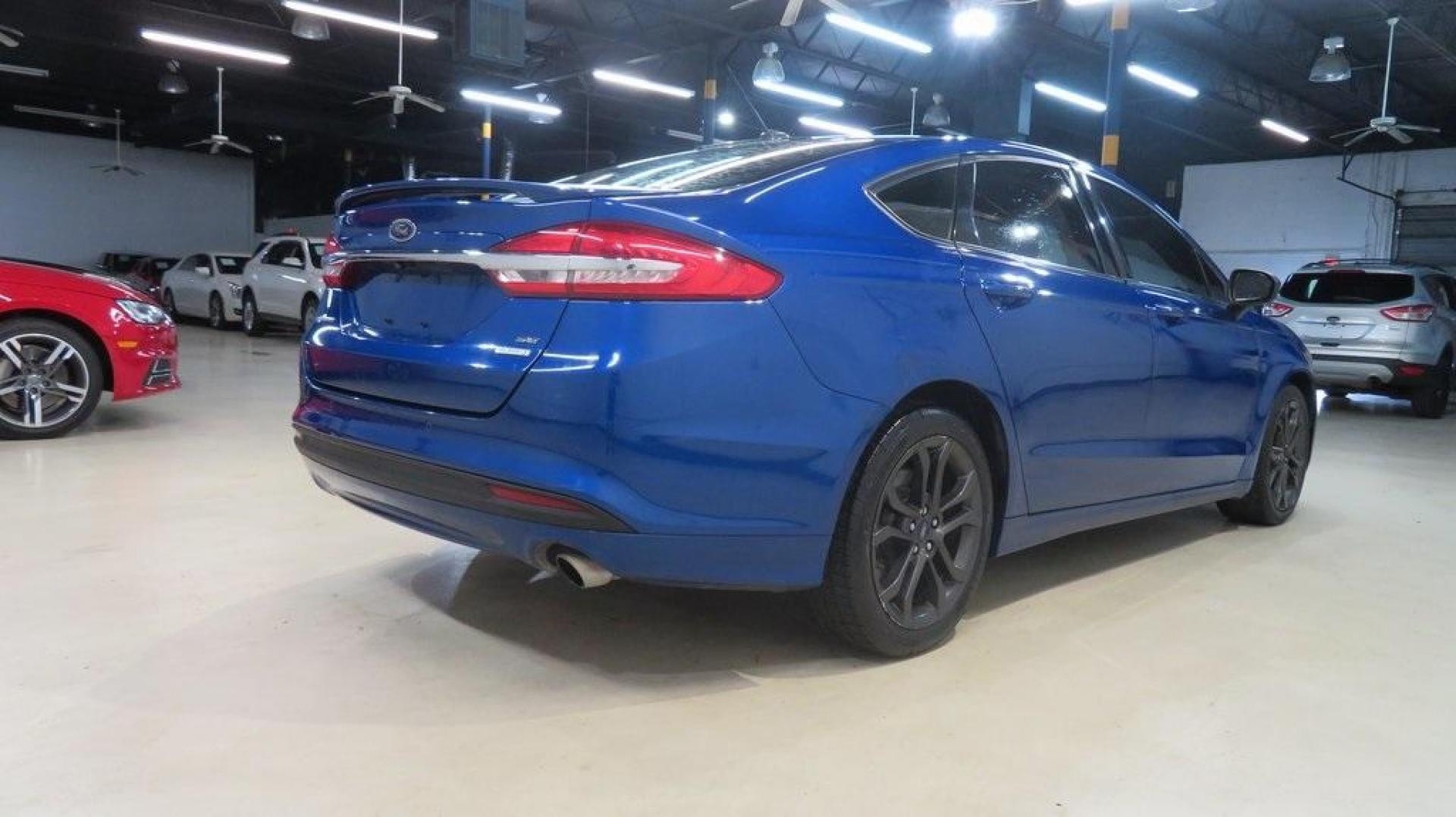 2018 Lightning Blue /Ebony Ford Fusion SE (3FA6P0HDXJR) with an 1.5L EcoBoost engine, Automatic transmission, located at 15300 Midway Rd., Addison, TX, 75001, (972) 702-0011, 32.958321, -96.838074 - 2018 Ford Fusion SE<br>Available now at Midway Auto Group Addison, Texas<br><br>Discover sophisticated styling and impressive performance in the 2018 Ford Fusion SE at Midway Auto Group. Designed for comfort and convenience, this sedan is perfect for daily commutes, weekend adventures, and everythi - Photo#2