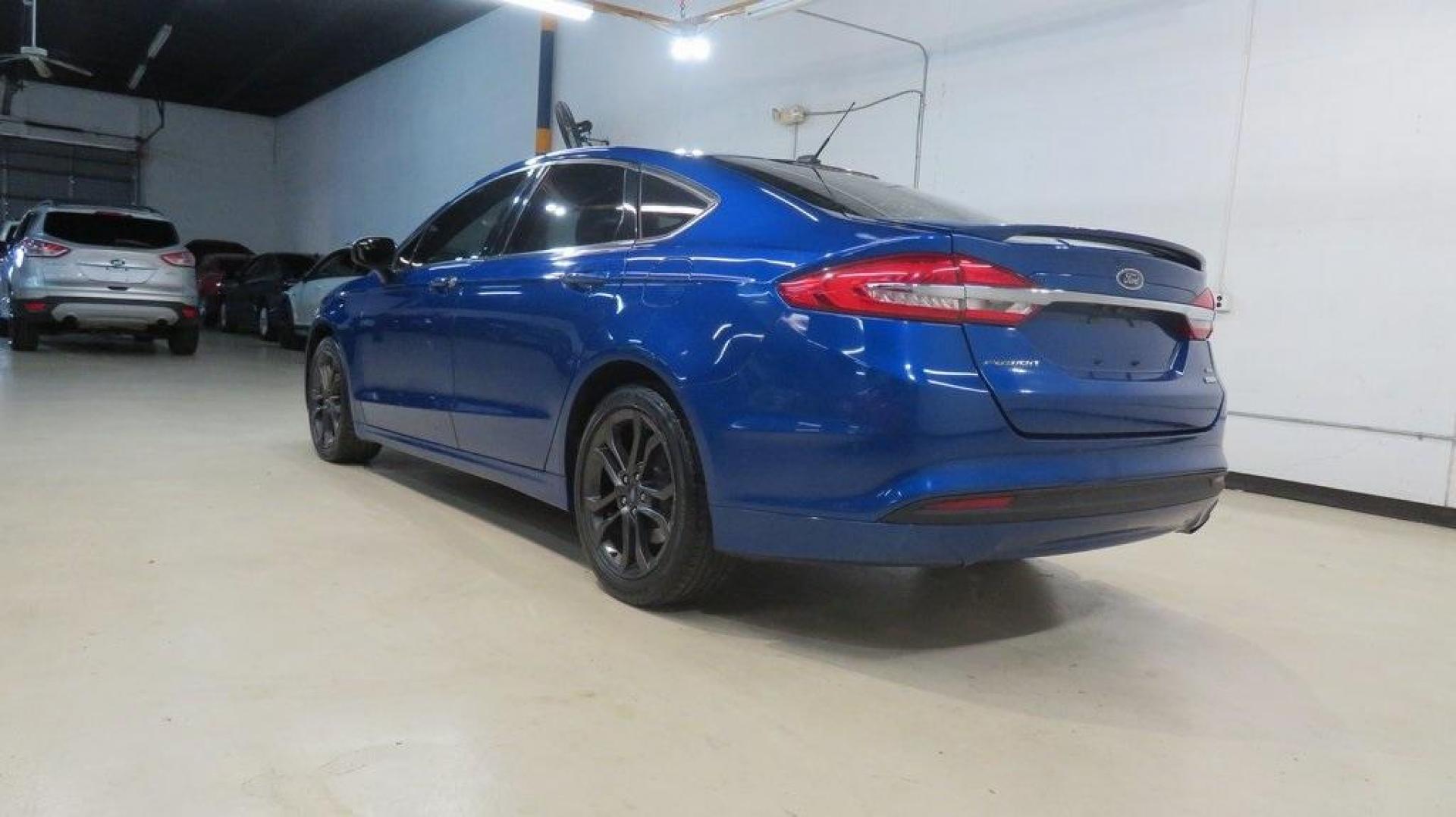 2018 Lightning Blue /Ebony Ford Fusion SE (3FA6P0HDXJR) with an 1.5L EcoBoost engine, Automatic transmission, located at 15300 Midway Rd., Addison, TX, 75001, (972) 702-0011, 32.958321, -96.838074 - 2018 Ford Fusion SE<br>Available now at Midway Auto Group Addison, Texas<br><br>Discover sophisticated styling and impressive performance in the 2018 Ford Fusion SE at Midway Auto Group. Designed for comfort and convenience, this sedan is perfect for daily commutes, weekend adventures, and everythi - Photo#3