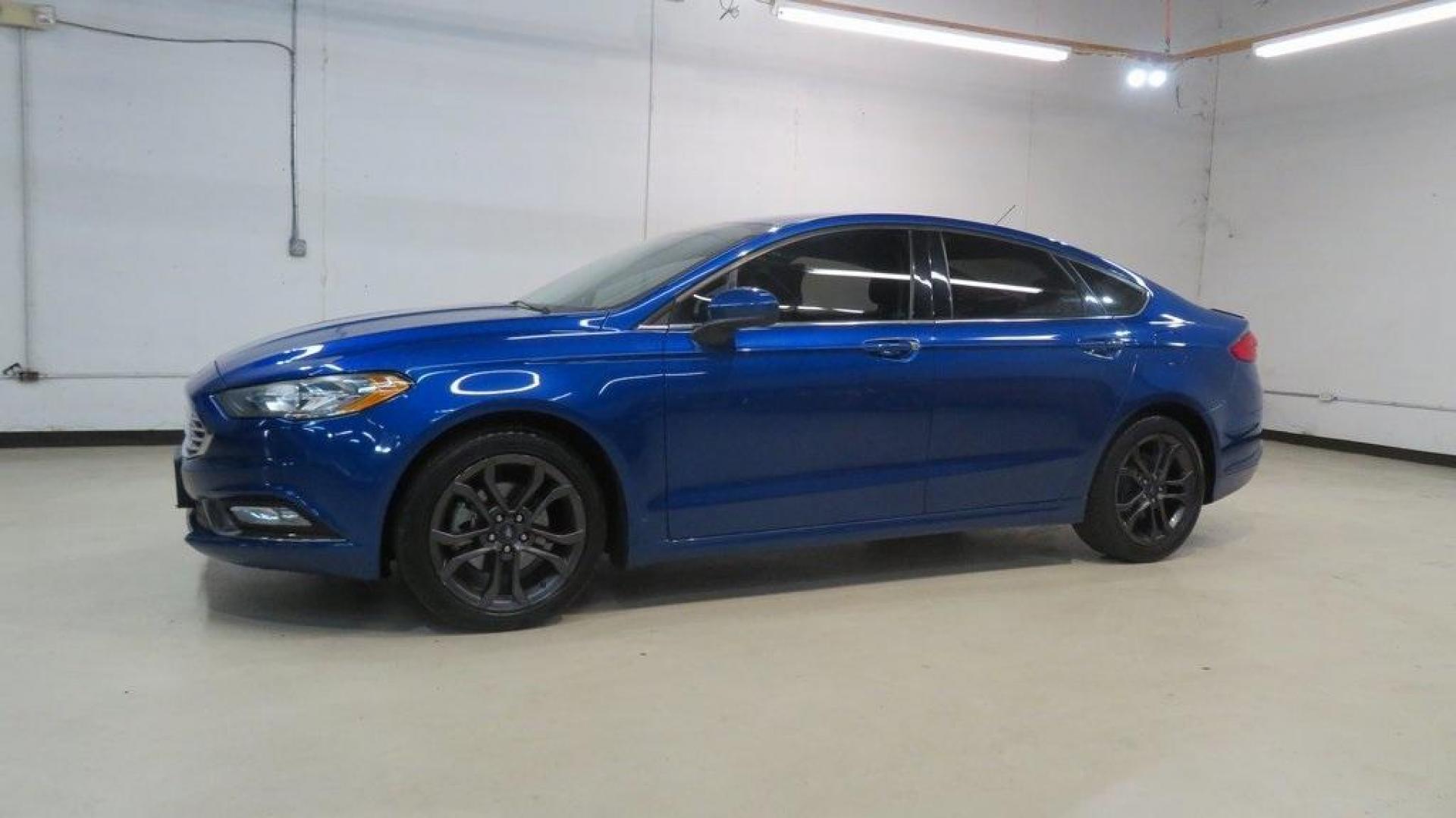 2018 Lightning Blue /Ebony Ford Fusion SE (3FA6P0HDXJR) with an 1.5L EcoBoost engine, Automatic transmission, located at 15300 Midway Rd., Addison, TX, 75001, (972) 702-0011, 32.958321, -96.838074 - 2018 Ford Fusion SE<br>Available now at Midway Auto Group Addison, Texas<br><br>Discover sophisticated styling and impressive performance in the 2018 Ford Fusion SE at Midway Auto Group. Designed for comfort and convenience, this sedan is perfect for daily commutes, weekend adventures, and everythi - Photo#4