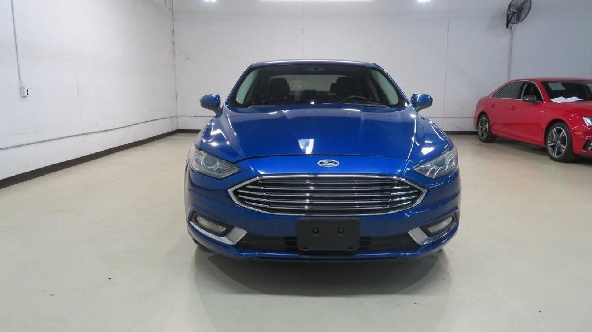 2018 Lightning Blue /Ebony Ford Fusion SE (3FA6P0HDXJR) with an 1.5L EcoBoost engine, Automatic transmission, located at 15300 Midway Rd., Addison, TX, 75001, (972) 702-0011, 32.958321, -96.838074 - 2018 Ford Fusion SE<br>Available now at Midway Auto Group Addison, Texas<br><br>Discover sophisticated styling and impressive performance in the 2018 Ford Fusion SE at Midway Auto Group. Designed for comfort and convenience, this sedan is perfect for daily commutes, weekend adventures, and everythi - Photo#5
