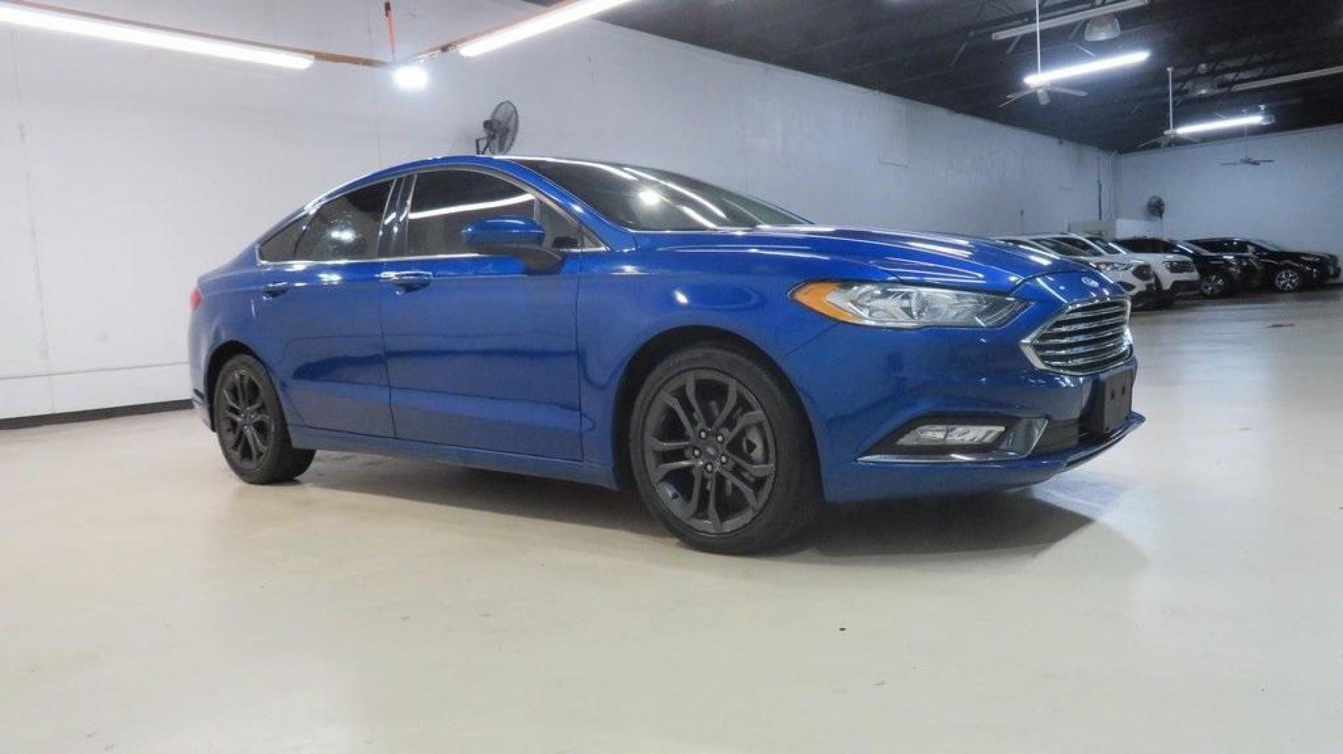 2018 Lightning Blue /Ebony Ford Fusion SE (3FA6P0HDXJR) with an 1.5L EcoBoost engine, Automatic transmission, located at 15300 Midway Rd., Addison, TX, 75001, (972) 702-0011, 32.958321, -96.838074 - 2018 Ford Fusion SE<br>Available now at Midway Auto Group Addison, Texas<br><br>Discover sophisticated styling and impressive performance in the 2018 Ford Fusion SE at Midway Auto Group. Designed for comfort and convenience, this sedan is perfect for daily commutes, weekend adventures, and everythi - Photo#6