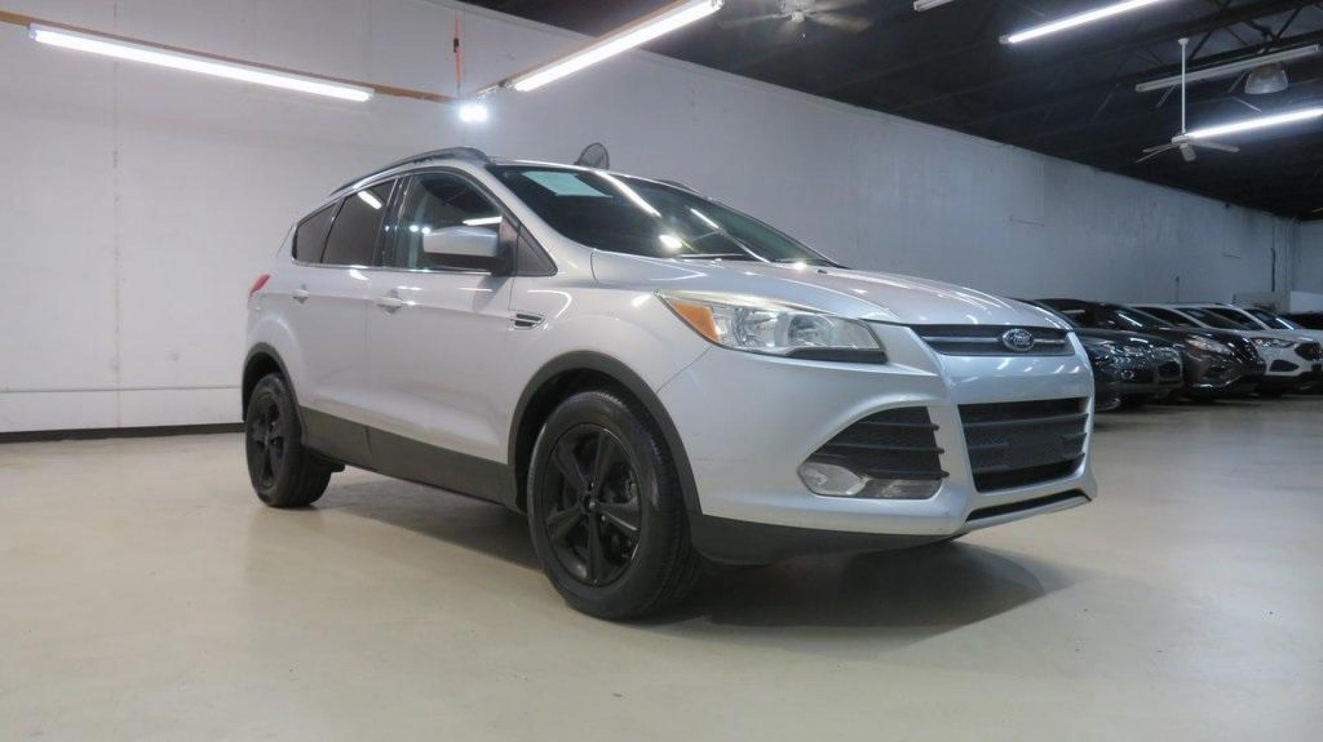 2014 Ingot Silver /Black Ford Escape SE (1FMCU0GX0EU) with an EcoBoost 1.6L I4 GTDi DOHC Turbocharged VCT engine, Automatic transmission, located at 15300 Midway Rd., Addison, TX, 75001, (972) 702-0011, 32.958321, -96.838074 - 2014 Ford Escape SE<br>Now Available at Midway Auto Group Addison, Texas<br><br>Versatile, efficient, and packed with comfort, the 2014 Ford Escape SE is a smart choice for drivers who need capability without sacrificing style. Whether you're commuting through Addison or embarking on weekend getawa - Photo#1