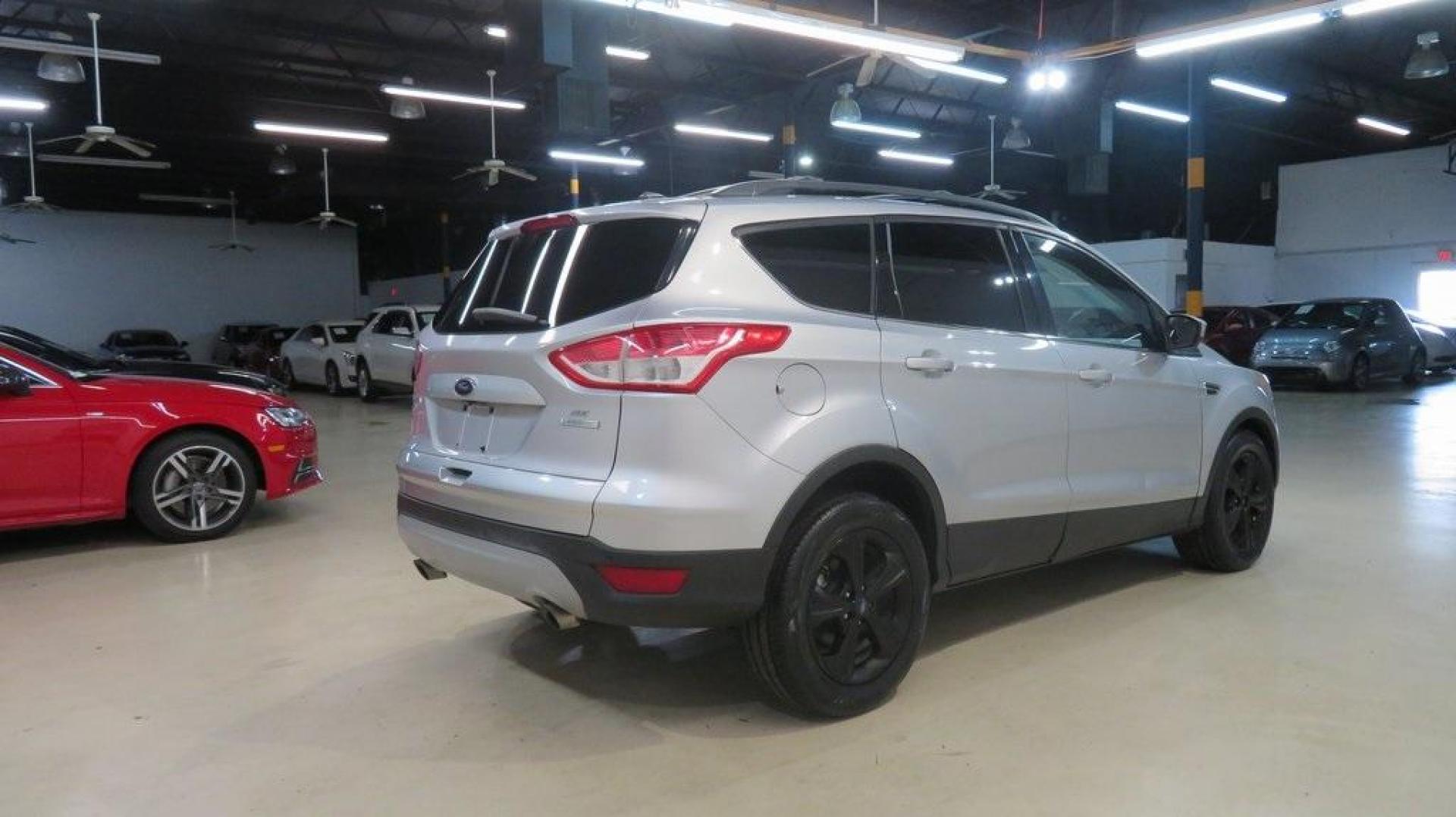 2014 Ingot Silver /Black Ford Escape SE (1FMCU0GX0EU) with an EcoBoost 1.6L I4 GTDi DOHC Turbocharged VCT engine, Automatic transmission, located at 15300 Midway Rd., Addison, TX, 75001, (972) 702-0011, 32.958321, -96.838074 - 2014 Ford Escape SE<br>Now Available at Midway Auto Group Addison, Texas<br><br>Versatile, efficient, and packed with comfort, the 2014 Ford Escape SE is a smart choice for drivers who need capability without sacrificing style. Whether you're commuting through Addison or embarking on weekend getawa - Photo#2