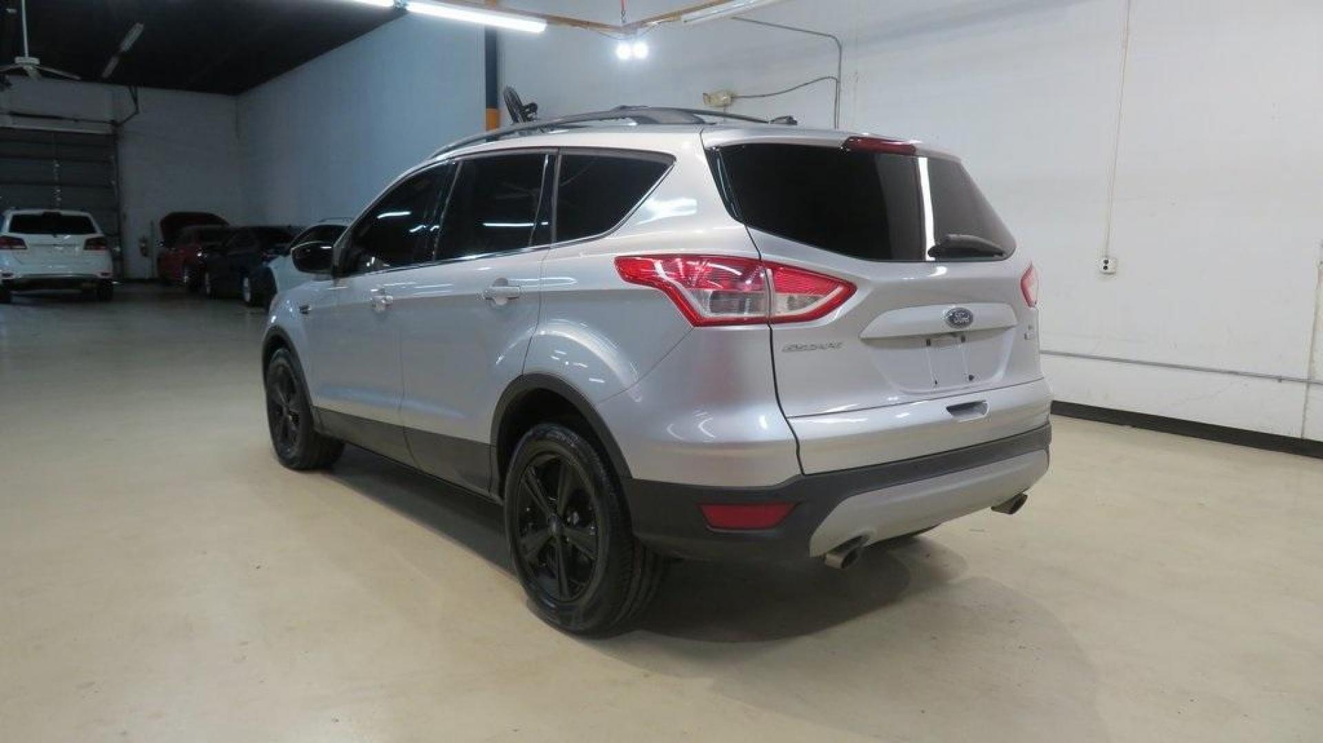2014 Ingot Silver /Black Ford Escape SE (1FMCU0GX0EU) with an EcoBoost 1.6L I4 GTDi DOHC Turbocharged VCT engine, Automatic transmission, located at 15300 Midway Rd., Addison, TX, 75001, (972) 702-0011, 32.958321, -96.838074 - 2014 Ford Escape SE<br>Now Available at Midway Auto Group Addison, Texas<br><br>Versatile, efficient, and packed with comfort, the 2014 Ford Escape SE is a smart choice for drivers who need capability without sacrificing style. Whether you're commuting through Addison or embarking on weekend getawa - Photo#4