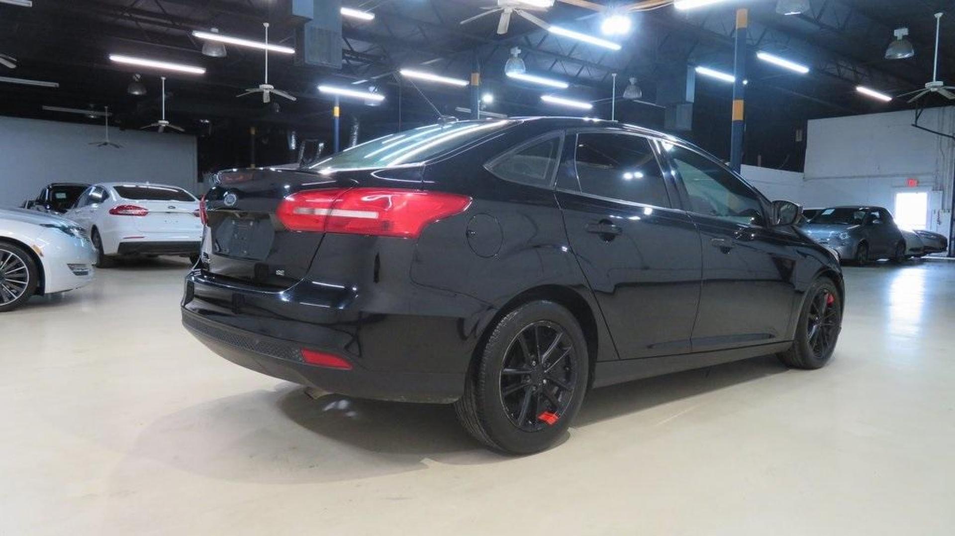 2018 Shadow Black /Charcoal Black Ford Focus SE (1FADP3F26JL) with an 2.0L I4 DGI Ti-VCT engine, Automatic transmission, located at 15300 Midway Rd., Addison, TX, 75001, (972) 702-0011, 32.958321, -96.838074 - Photo#2