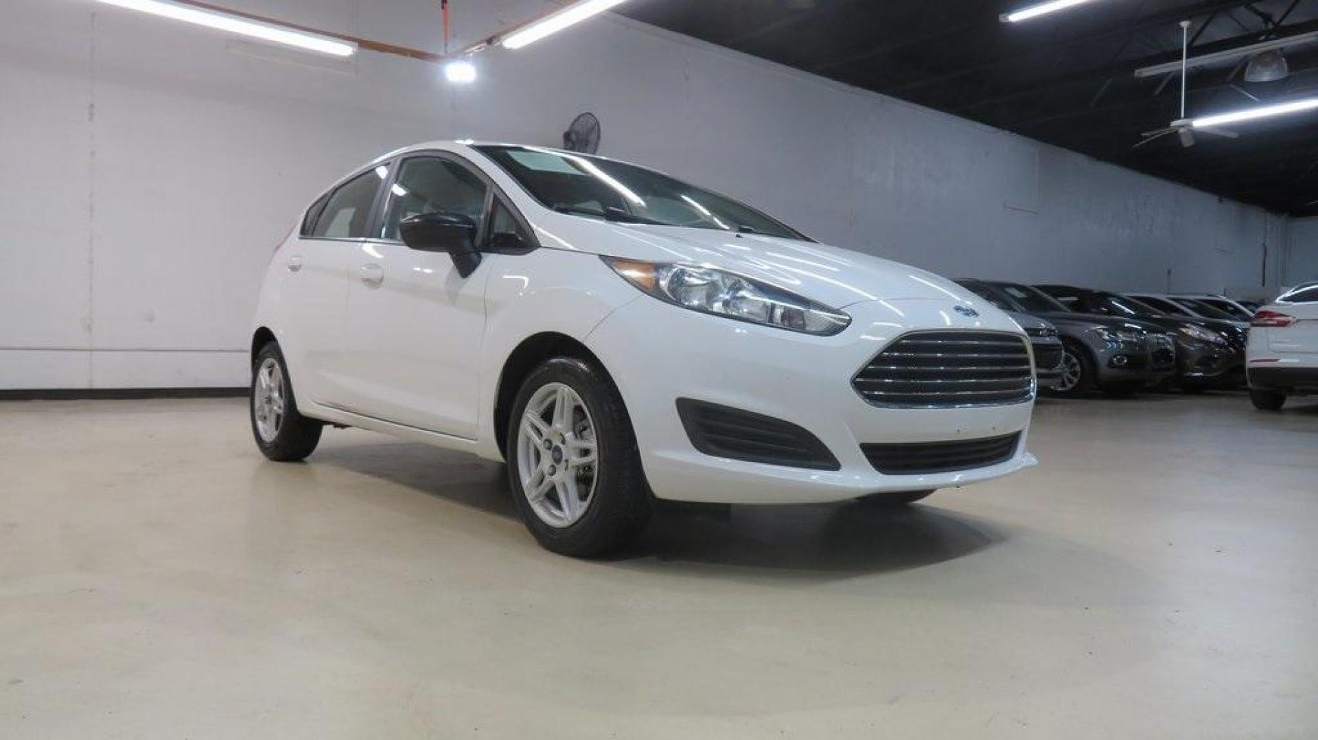 2018 Oxford White /Medium Light Stone Ford Fiesta SE (3FADP4EJ6JM) with an 1.6L I4 Ti-VCT engine, Automatic transmission, located at 15300 Midway Rd., Addison, TX, 75001, (972) 702-0011, 32.958321, -96.838074 - 2018 Ford Fiesta SE Hatchback<br>Now Available at Midway Auto Group Addison, Texas<br><br>Compact, stylish, and packed with value, the 2018 Ford Fiesta SE Hatchback is a fun-to-drive car that offers smart tech, impressive fuel economy, and hatchback versatility. Whether you're commuting through Add - Photo#1