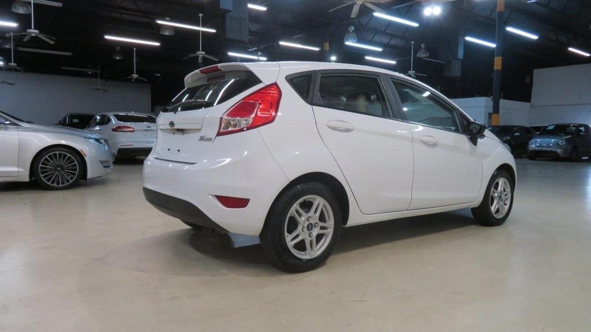 2018 Oxford White /Medium Light Stone Ford Fiesta SE (3FADP4EJ6JM) with an 1.6L I4 Ti-VCT engine, Automatic transmission, located at 15300 Midway Rd., Addison, TX, 75001, (972) 702-0011, 32.958321, -96.838074 - 2018 Ford Fiesta SE Hatchback<br>Now Available at Midway Auto Group Addison, Texas<br><br>Compact, stylish, and packed with value, the 2018 Ford Fiesta SE Hatchback is a fun-to-drive car that offers smart tech, impressive fuel economy, and hatchback versatility. Whether you're commuting through Add - Photo#2