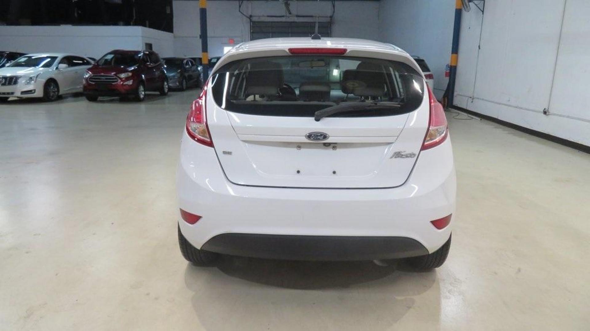 2018 Oxford White /Medium Light Stone Ford Fiesta SE (3FADP4EJ6JM) with an 1.6L I4 Ti-VCT engine, Automatic transmission, located at 15300 Midway Rd., Addison, TX, 75001, (972) 702-0011, 32.958321, -96.838074 - 2018 Ford Fiesta SE Hatchback<br>Now Available at Midway Auto Group Addison, Texas<br><br>Compact, stylish, and packed with value, the 2018 Ford Fiesta SE Hatchback is a fun-to-drive car that offers smart tech, impressive fuel economy, and hatchback versatility. Whether you're commuting through Add - Photo#7