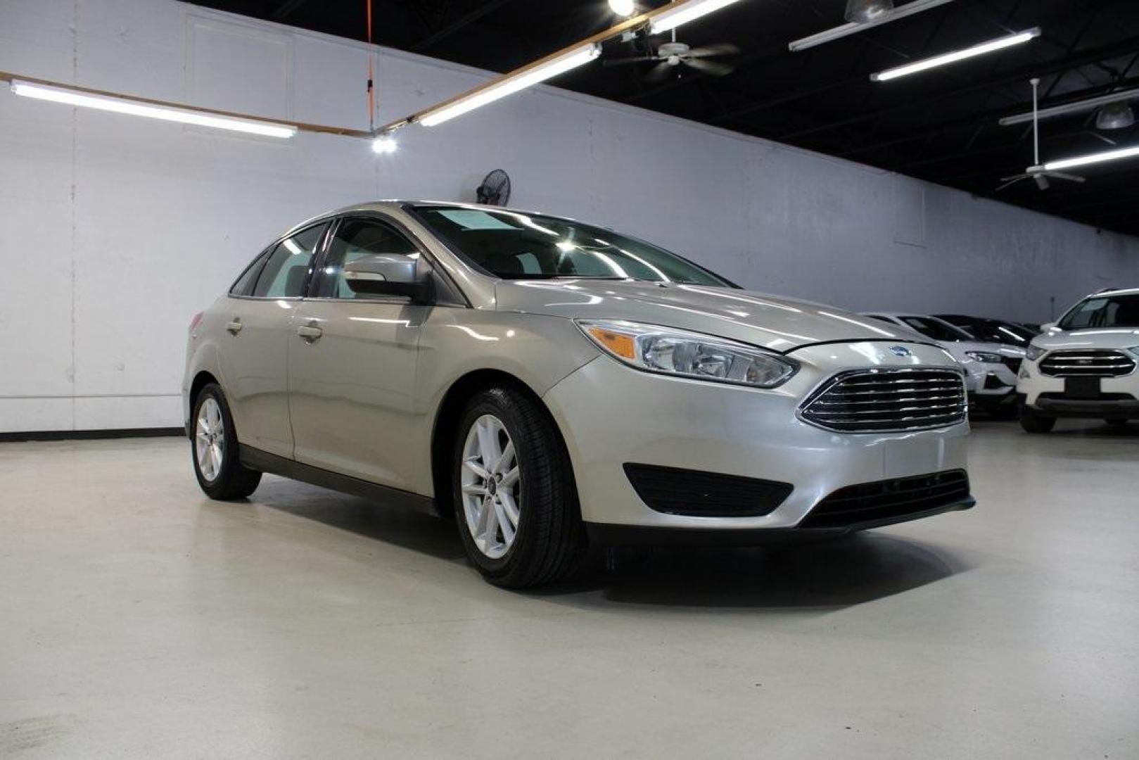 2015 Tectonic /Medium Light Stone Ford Focus SE (1FADP3F29FL) with an 2.0L 4-Cylinder DGI Flex Fuel DOHC engine, Automatic transmission, located at 15300 Midway Rd., Addison, TX, 75001, (972) 702-0011, 32.958321, -96.838074 - 2015 Ford Focus SE<br>Now Available at Midway Auto Group Addison, Texas<br><br>Efficient, comfortable, and packed with useful tech, the 2015 Ford Focus SE is the ideal compact sedan for daily driving around Addison or longer commutes across Texas. With a sleek design and responsive handling, it off - Photo#1