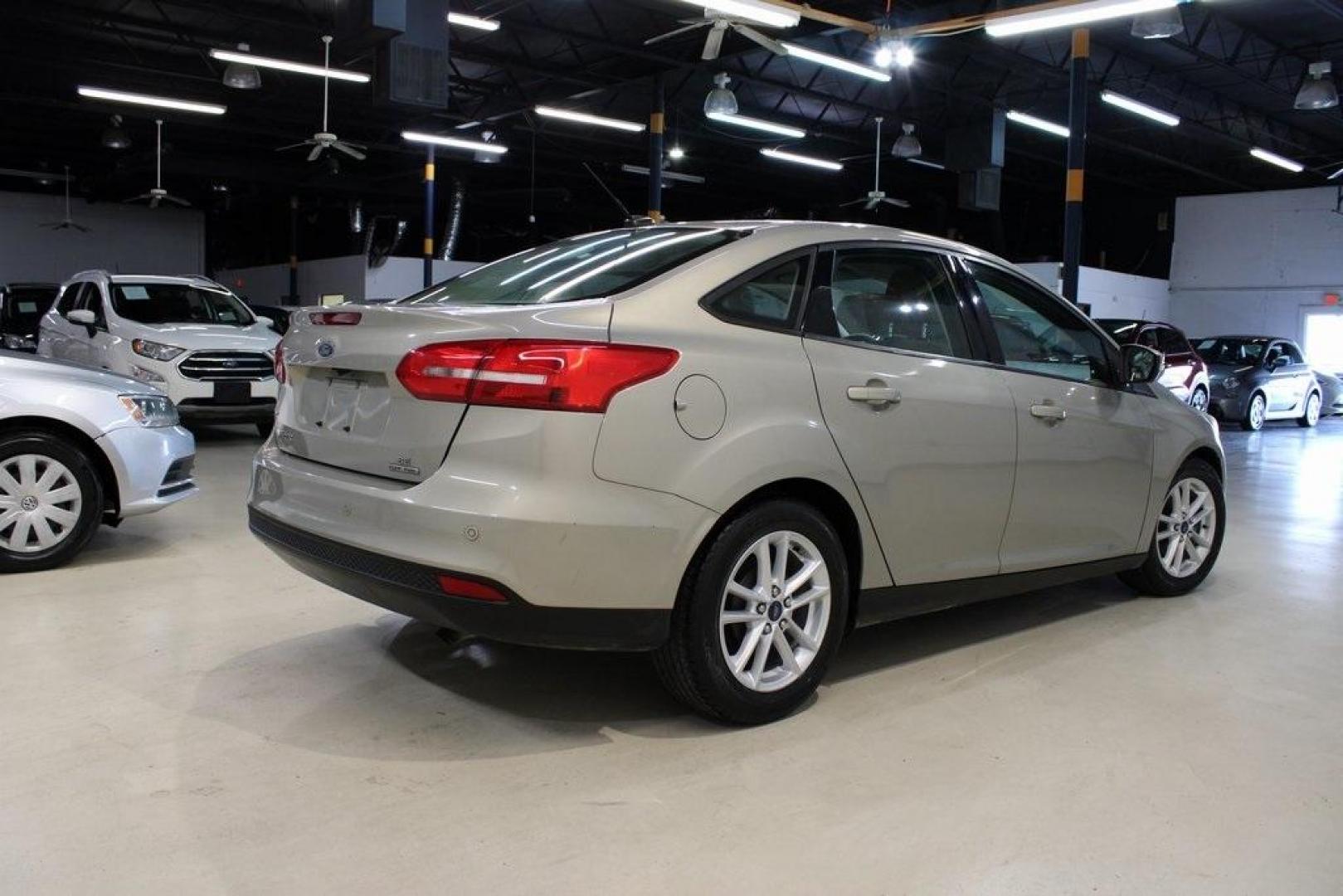 2015 Tectonic /Medium Light Stone Ford Focus SE (1FADP3F29FL) with an 2.0L 4-Cylinder DGI Flex Fuel DOHC engine, Automatic transmission, located at 15300 Midway Rd., Addison, TX, 75001, (972) 702-0011, 32.958321, -96.838074 - 2015 Ford Focus SE<br>Now Available at Midway Auto Group Addison, Texas<br><br>Efficient, comfortable, and packed with useful tech, the 2015 Ford Focus SE is the ideal compact sedan for daily driving around Addison or longer commutes across Texas. With a sleek design and responsive handling, it off - Photo#2