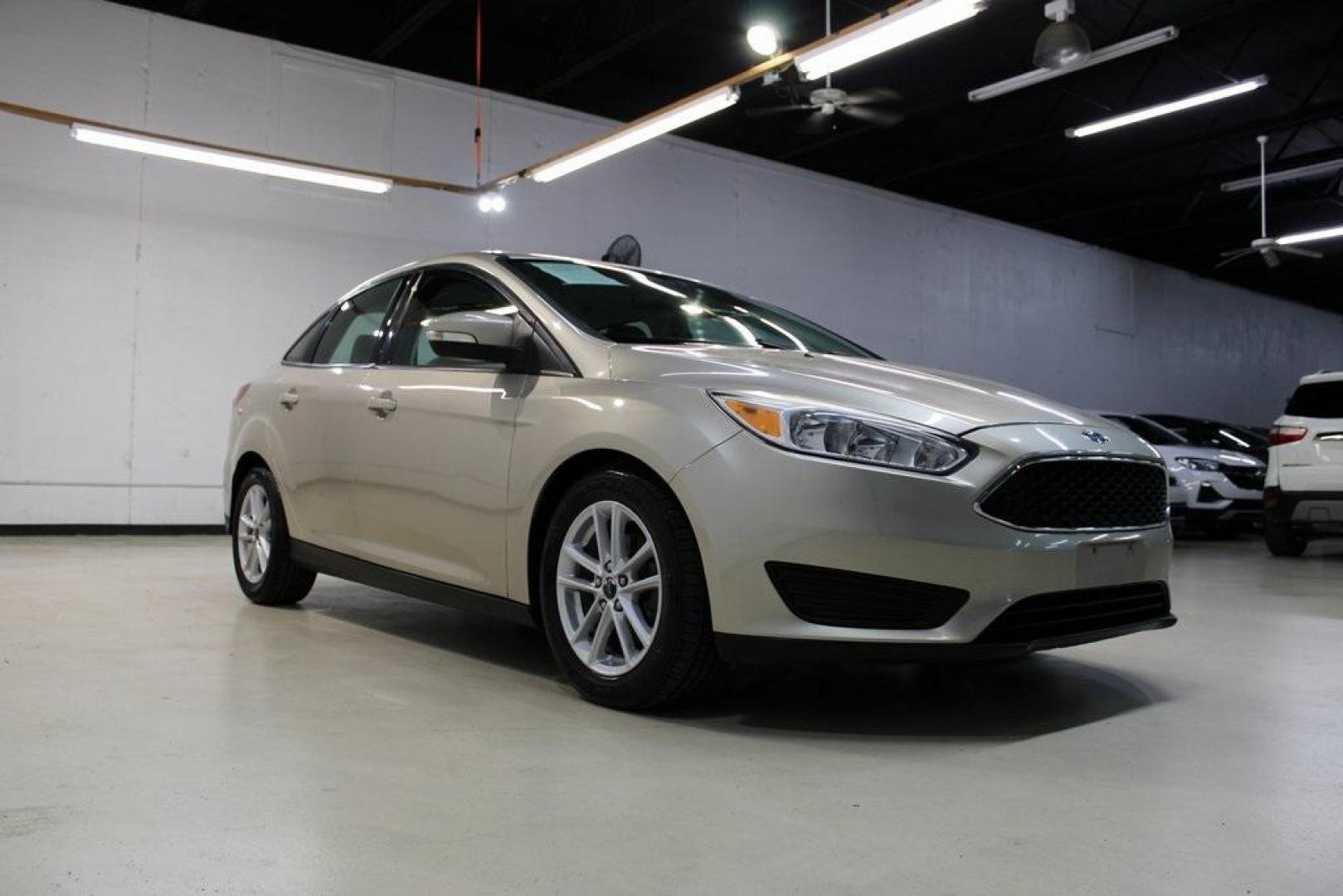 2017 White Gold /Medium Light Stone Ford Focus SE (1FADP3F20HL) with an 2.0L 4-Cylinder DGI Flex Fuel Turbocharged DOHC engine, Automatic transmission, located at 15300 Midway Rd., Addison, TX, 75001, (972) 702-0011, 32.958321, -96.838074 - 2017 Ford Focus SE<br>Now Available at Midway Auto Group Addison, Texas<br><br>Smart, efficient, and comfortable, the 2017 Ford Focus SE is a compact sedan that delivers excellent fuel economy, responsive handling, and modern tech at a budget-friendly price. Whether youre commuting through Addison - Photo#1