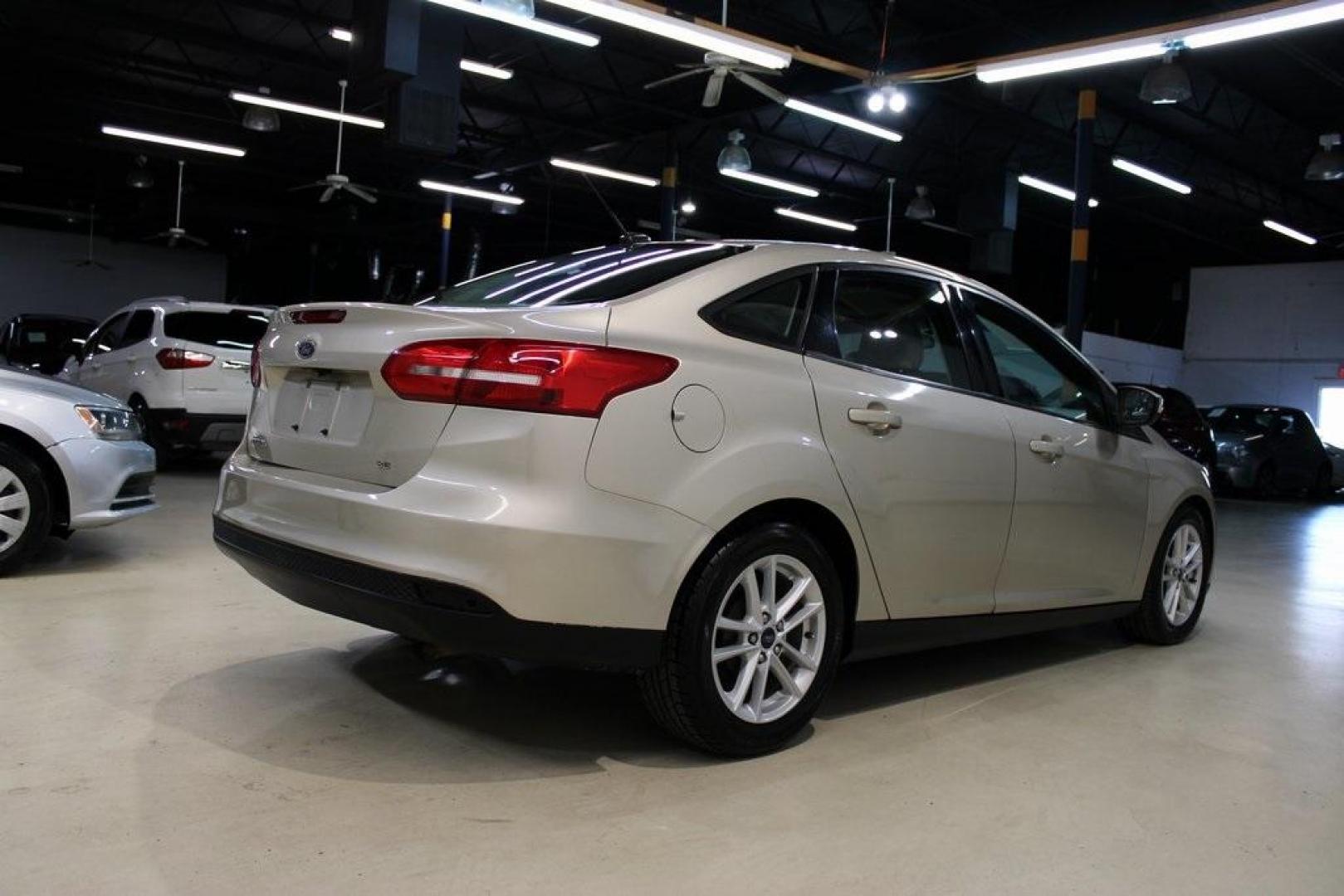 2017 White Gold /Medium Light Stone Ford Focus SE (1FADP3F20HL) with an 2.0L 4-Cylinder DGI Flex Fuel Turbocharged DOHC engine, Automatic transmission, located at 15300 Midway Rd., Addison, TX, 75001, (972) 702-0011, 32.958321, -96.838074 - 2017 Ford Focus SE<br>Now Available at Midway Auto Group Addison, Texas<br><br>Smart, efficient, and comfortable, the 2017 Ford Focus SE is a compact sedan that delivers excellent fuel economy, responsive handling, and modern tech at a budget-friendly price. Whether youre commuting through Addison - Photo#2
