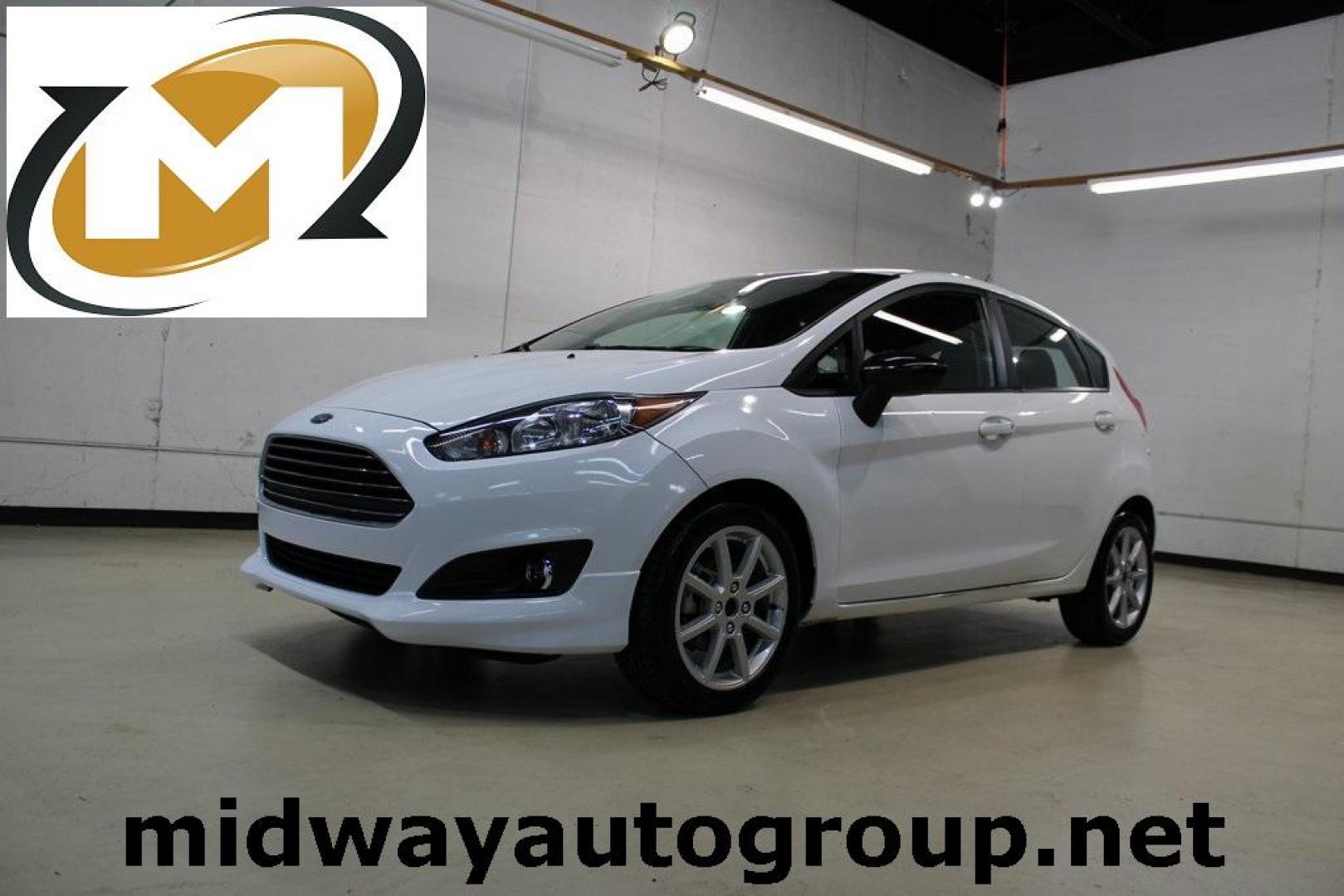 2019 Oxford White /Black Ford Fiesta SE (3FADP4EJ1KM) with an 1.6L I4 Ti-VCT engine, Automatic transmission, located at 15300 Midway Rd., Addison, TX, 75001, (972) 702-0011, 32.958321, -96.838074 - 2019 Ford Fiesta SE Hatchback<br>Now Available at Midway Auto Group Addison, Texas<br><br>Sporty, efficient, and fun to drive, the 2019 Ford Fiesta SE Hatchback delivers big versatility in a compact package. With its hatchback design, nimble handling, and great fuel economy, this Fiesta is perfect - Photo#0