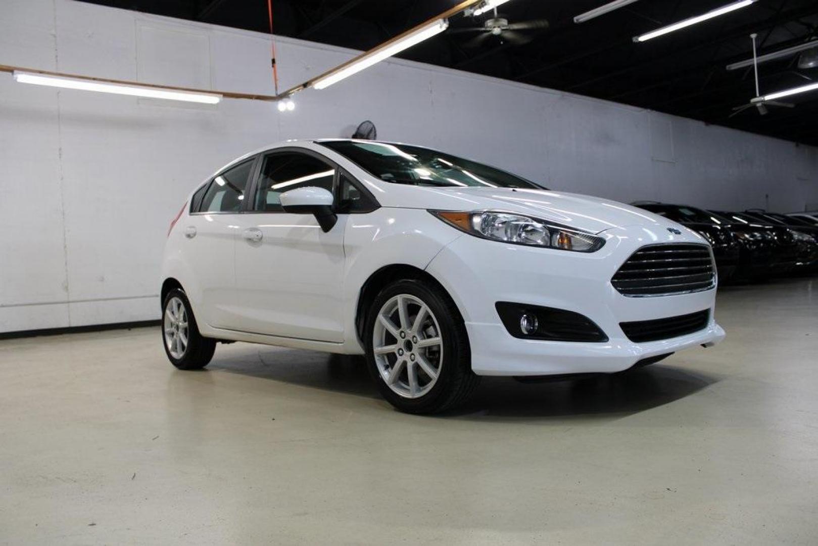 2019 Oxford White /Black Ford Fiesta SE (3FADP4EJ1KM) with an 1.6L I4 Ti-VCT engine, Automatic transmission, located at 15300 Midway Rd., Addison, TX, 75001, (972) 702-0011, 32.958321, -96.838074 - 2019 Ford Fiesta SE Hatchback<br>Now Available at Midway Auto Group Addison, Texas<br><br>Sporty, efficient, and fun to drive, the 2019 Ford Fiesta SE Hatchback delivers big versatility in a compact package. With its hatchback design, nimble handling, and great fuel economy, this Fiesta is perfect - Photo#1