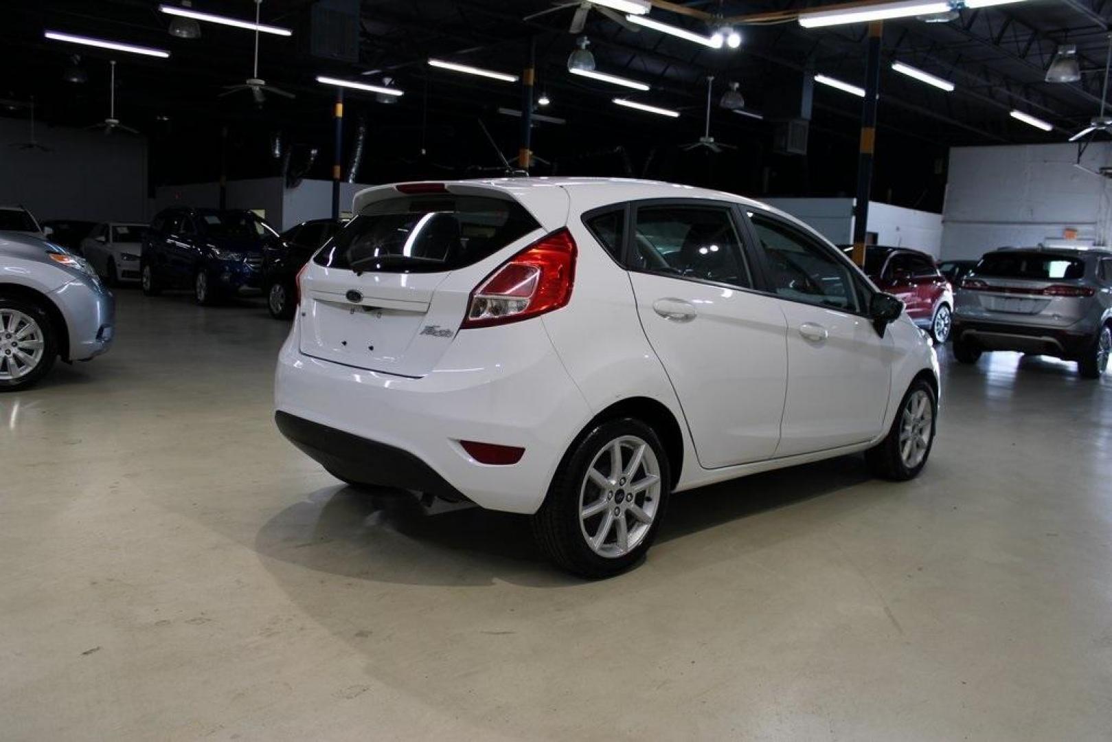 2019 Oxford White /Black Ford Fiesta SE (3FADP4EJ1KM) with an 1.6L I4 Ti-VCT engine, Automatic transmission, located at 15300 Midway Rd., Addison, TX, 75001, (972) 702-0011, 32.958321, -96.838074 - 2019 Ford Fiesta SE Hatchback<br>Now Available at Midway Auto Group Addison, Texas<br><br>Sporty, efficient, and fun to drive, the 2019 Ford Fiesta SE Hatchback delivers big versatility in a compact package. With its hatchback design, nimble handling, and great fuel economy, this Fiesta is perfect - Photo#2