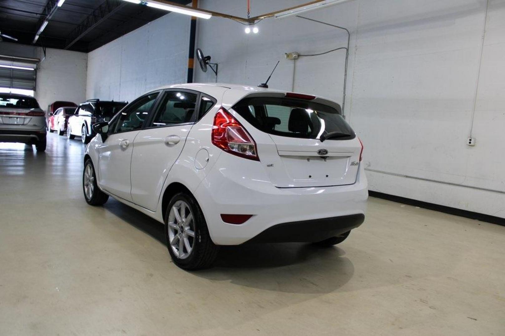 2019 Oxford White /Black Ford Fiesta SE (3FADP4EJ1KM) with an 1.6L I4 Ti-VCT engine, Automatic transmission, located at 15300 Midway Rd., Addison, TX, 75001, (972) 702-0011, 32.958321, -96.838074 - 2019 Ford Fiesta SE Hatchback<br>Now Available at Midway Auto Group Addison, Texas<br><br>Sporty, efficient, and fun to drive, the 2019 Ford Fiesta SE Hatchback delivers big versatility in a compact package. With its hatchback design, nimble handling, and great fuel economy, this Fiesta is perfect - Photo#3