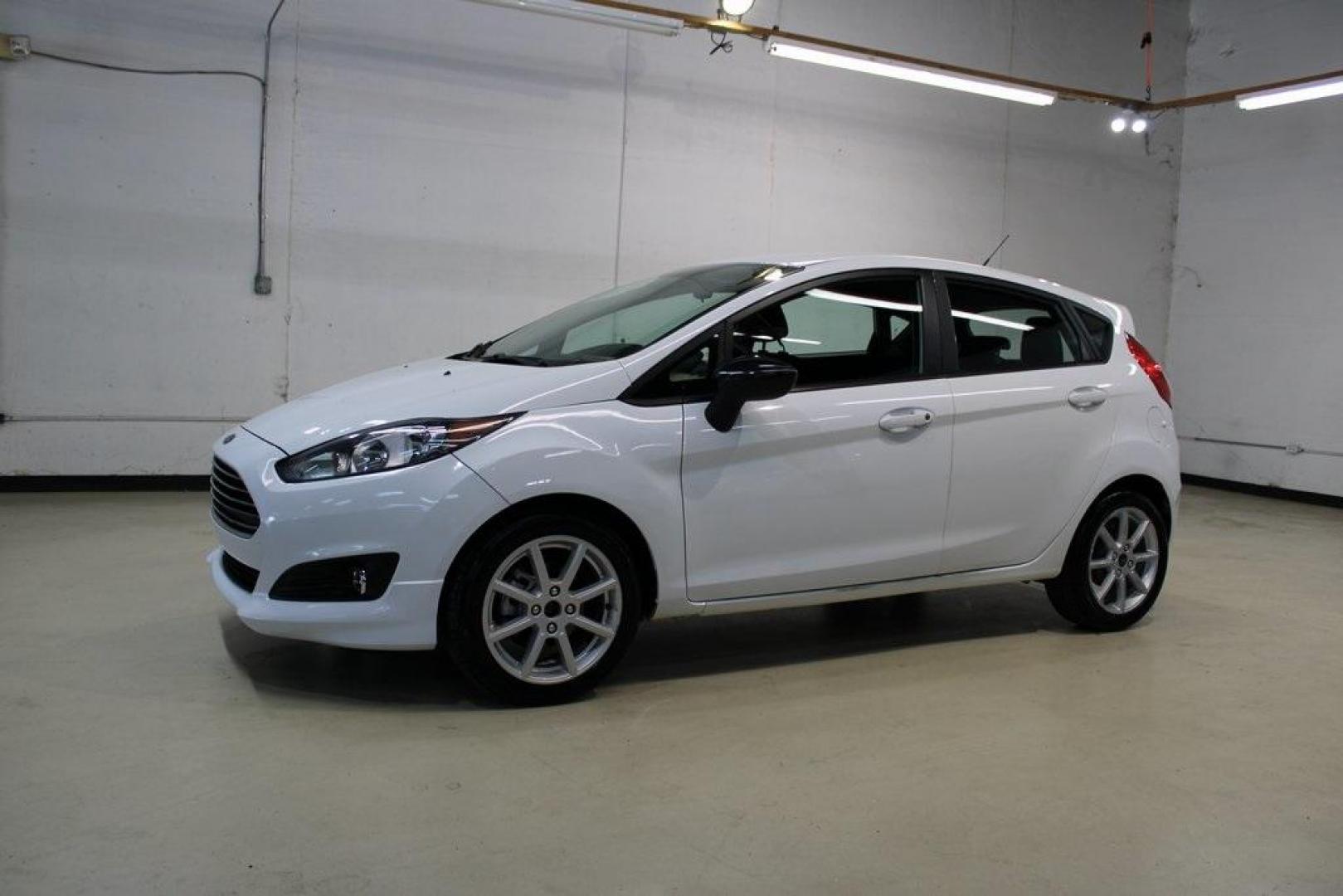 2019 Oxford White /Black Ford Fiesta SE (3FADP4EJ1KM) with an 1.6L I4 Ti-VCT engine, Automatic transmission, located at 15300 Midway Rd., Addison, TX, 75001, (972) 702-0011, 32.958321, -96.838074 - 2019 Ford Fiesta SE Hatchback<br>Now Available at Midway Auto Group Addison, Texas<br><br>Sporty, efficient, and fun to drive, the 2019 Ford Fiesta SE Hatchback delivers big versatility in a compact package. With its hatchback design, nimble handling, and great fuel economy, this Fiesta is perfect - Photo#4
