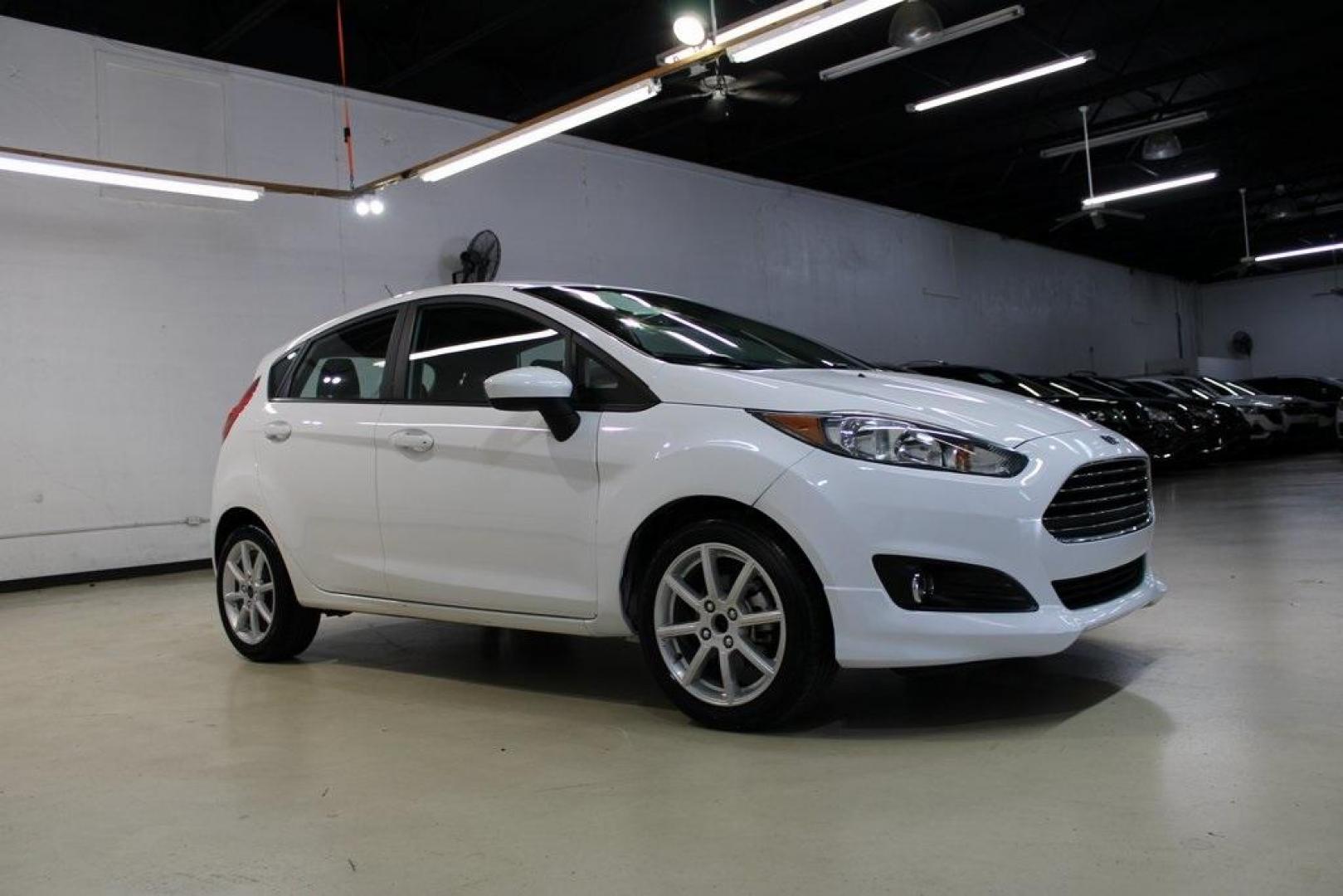 2019 Oxford White /Black Ford Fiesta SE (3FADP4EJ1KM) with an 1.6L I4 Ti-VCT engine, Automatic transmission, located at 15300 Midway Rd., Addison, TX, 75001, (972) 702-0011, 32.958321, -96.838074 - 2019 Ford Fiesta SE Hatchback<br>Now Available at Midway Auto Group Addison, Texas<br><br>Sporty, efficient, and fun to drive, the 2019 Ford Fiesta SE Hatchback delivers big versatility in a compact package. With its hatchback design, nimble handling, and great fuel economy, this Fiesta is perfect - Photo#6