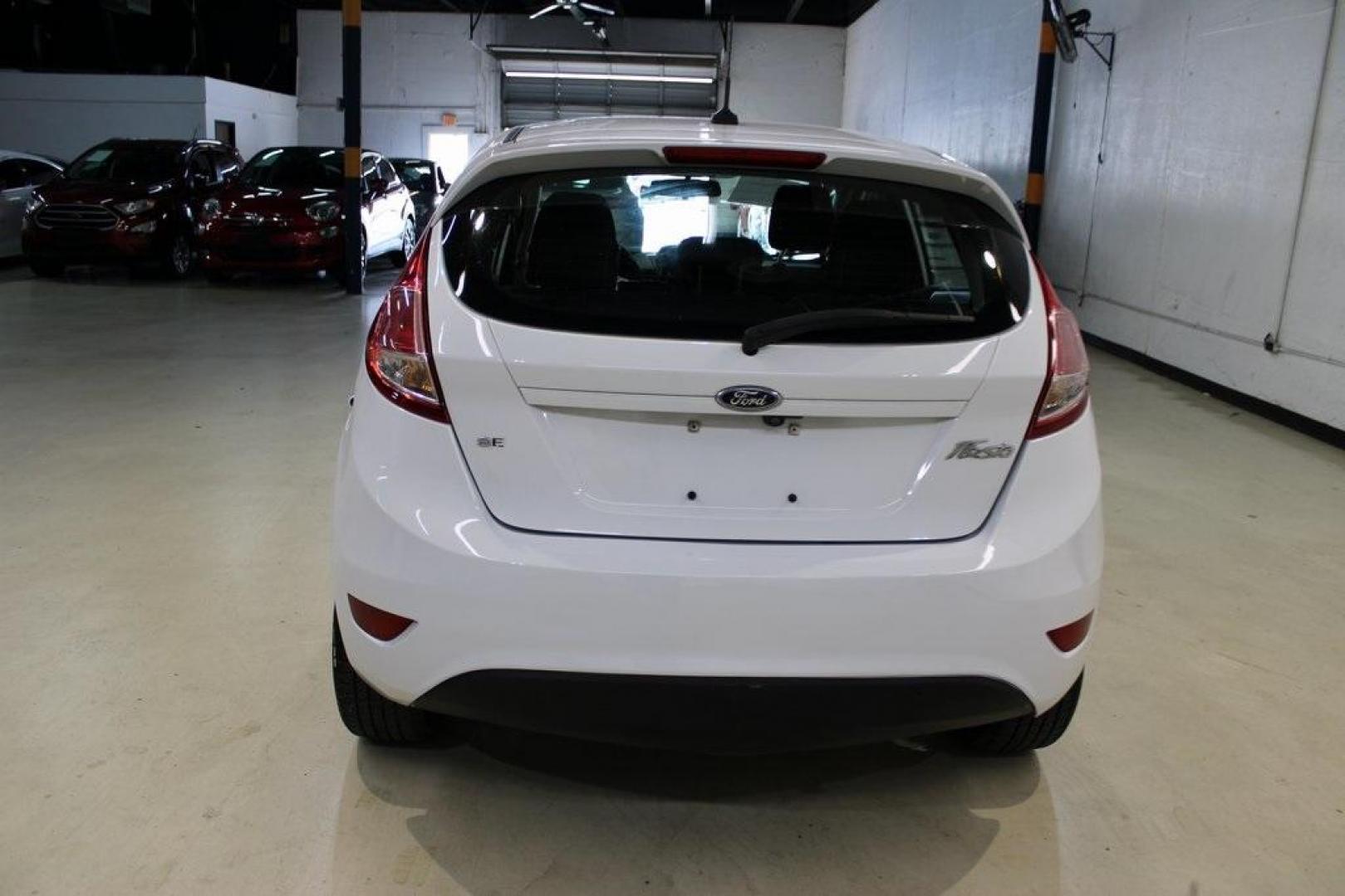 2019 Oxford White /Black Ford Fiesta SE (3FADP4EJ1KM) with an 1.6L I4 Ti-VCT engine, Automatic transmission, located at 15300 Midway Rd., Addison, TX, 75001, (972) 702-0011, 32.958321, -96.838074 - 2019 Ford Fiesta SE Hatchback<br>Now Available at Midway Auto Group Addison, Texas<br><br>Sporty, efficient, and fun to drive, the 2019 Ford Fiesta SE Hatchback delivers big versatility in a compact package. With its hatchback design, nimble handling, and great fuel economy, this Fiesta is perfect - Photo#7