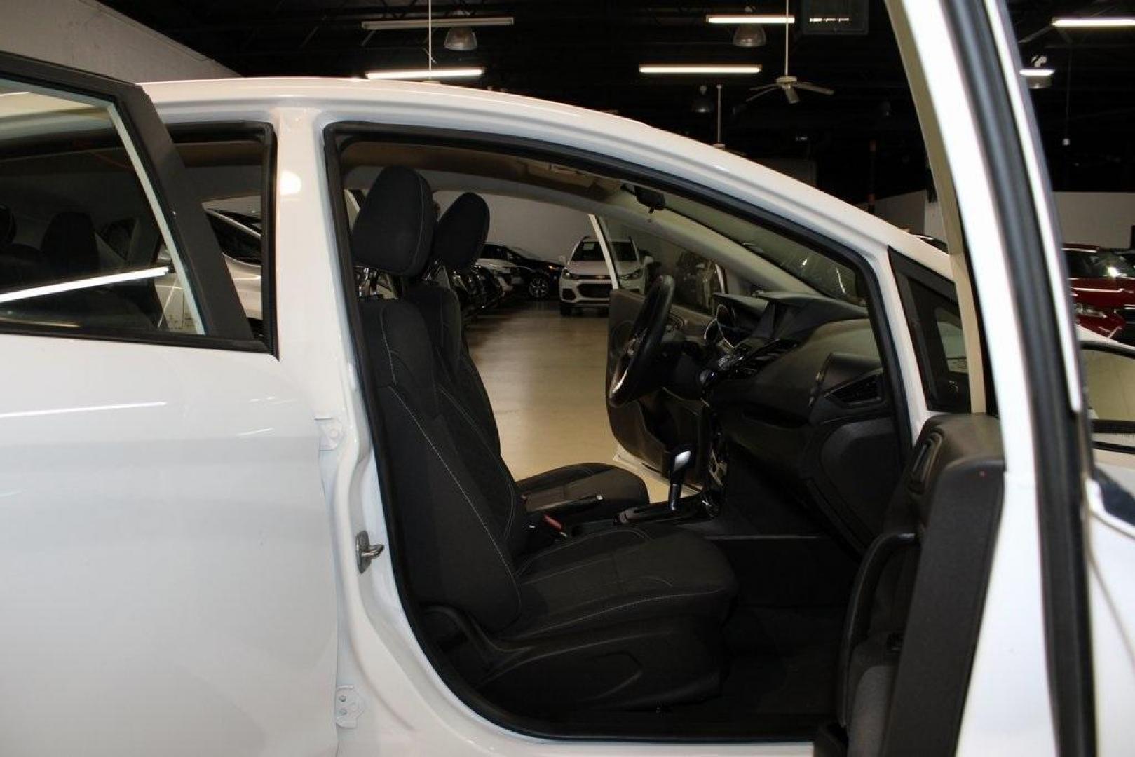 2019 Oxford White /Black Ford Fiesta SE (3FADP4EJ1KM) with an 1.6L I4 Ti-VCT engine, Automatic transmission, located at 15300 Midway Rd., Addison, TX, 75001, (972) 702-0011, 32.958321, -96.838074 - 2019 Ford Fiesta SE Hatchback<br>Now Available at Midway Auto Group Addison, Texas<br><br>Sporty, efficient, and fun to drive, the 2019 Ford Fiesta SE Hatchback delivers big versatility in a compact package. With its hatchback design, nimble handling, and great fuel economy, this Fiesta is perfect - Photo#12