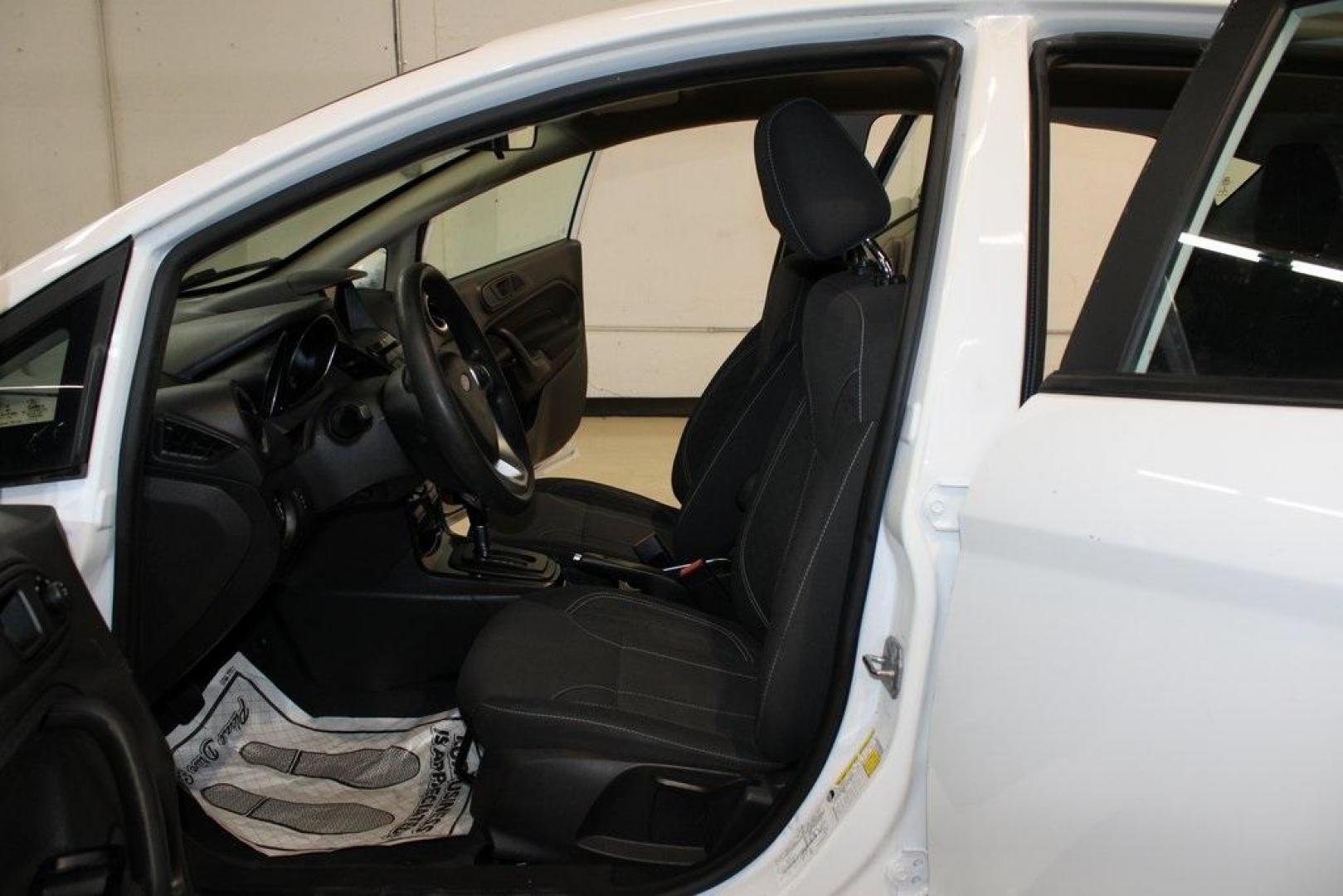 2019 Oxford White /Black Ford Fiesta SE (3FADP4EJ1KM) with an 1.6L I4 Ti-VCT engine, Automatic transmission, located at 15300 Midway Rd., Addison, TX, 75001, (972) 702-0011, 32.958321, -96.838074 - 2019 Ford Fiesta SE Hatchback<br>Now Available at Midway Auto Group Addison, Texas<br><br>Sporty, efficient, and fun to drive, the 2019 Ford Fiesta SE Hatchback delivers big versatility in a compact package. With its hatchback design, nimble handling, and great fuel economy, this Fiesta is perfect - Photo#13