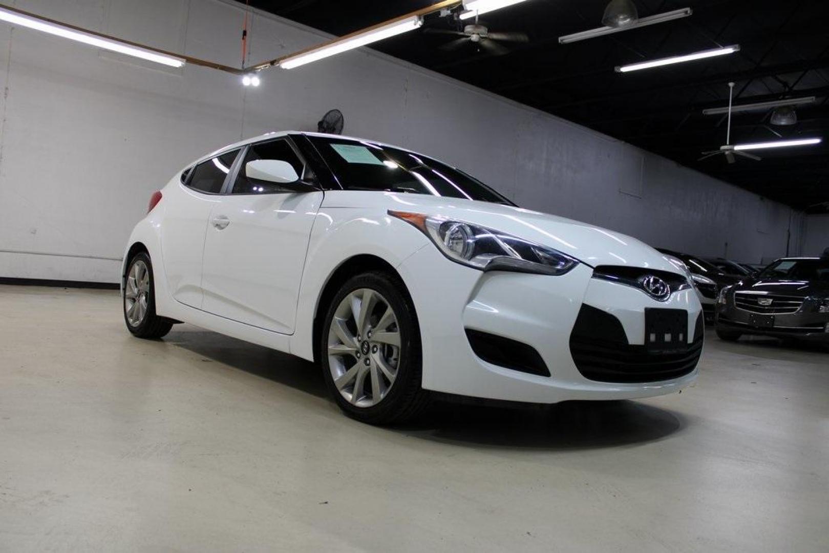2016 White /Black Hyundai Veloster Base (KMHTC6AD8GU) with an 1.6L I4 DGI DOHC 16V ULEV II 132hp engine, Automatic transmission, located at 15300 Midway Rd., Addison, TX, 75001, (972) 702-0011, 32.958321, -96.838074 - 2016 Hyundai Veloster<br>Now Available at Midway Auto Group Addison, Texas<br><br>Sporty, unique, and fun to drive, the 2016 Hyundai Veloster stands out with its bold design and hatchback versatility. Perfect for drivers who want style, efficiency, and modern tech in one compact package, the Velost - Photo#1