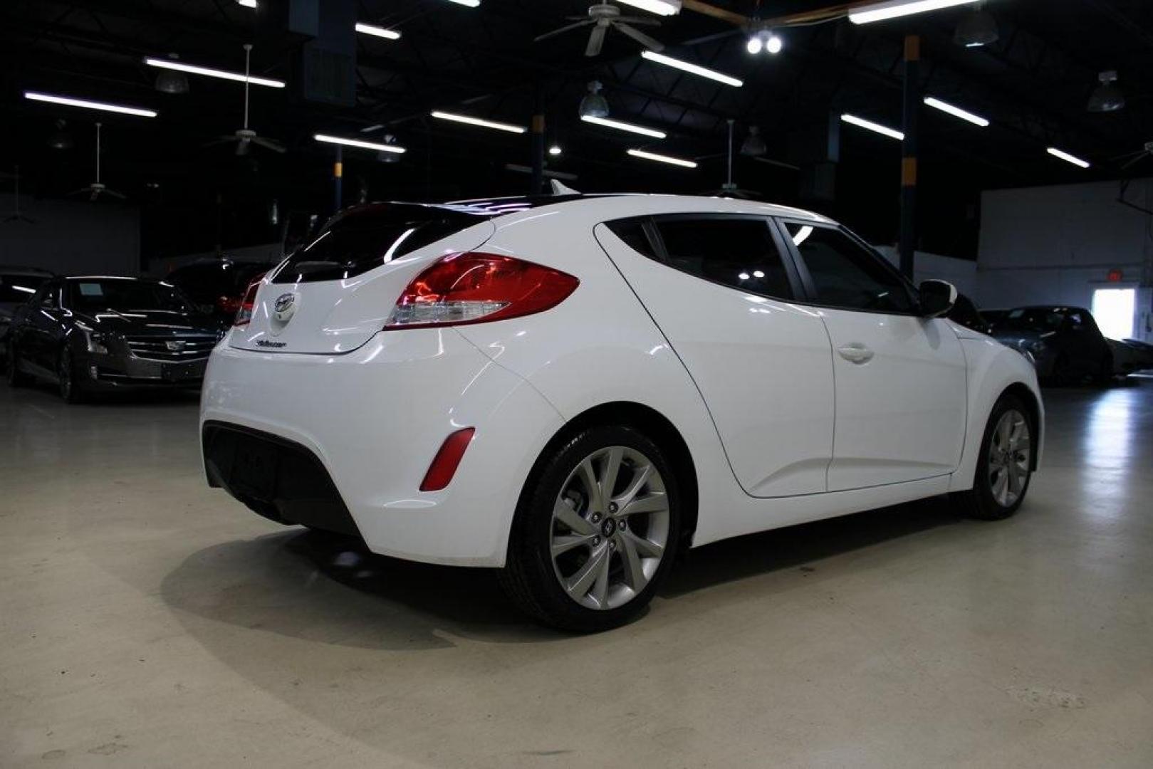 2016 White /Black Hyundai Veloster Base (KMHTC6AD8GU) with an 1.6L I4 DGI DOHC 16V ULEV II 132hp engine, Automatic transmission, located at 15300 Midway Rd., Addison, TX, 75001, (972) 702-0011, 32.958321, -96.838074 - 2016 Hyundai Veloster<br>Now Available at Midway Auto Group Addison, Texas<br><br>Sporty, unique, and fun to drive, the 2016 Hyundai Veloster stands out with its bold design and hatchback versatility. Perfect for drivers who want style, efficiency, and modern tech in one compact package, the Velost - Photo#2