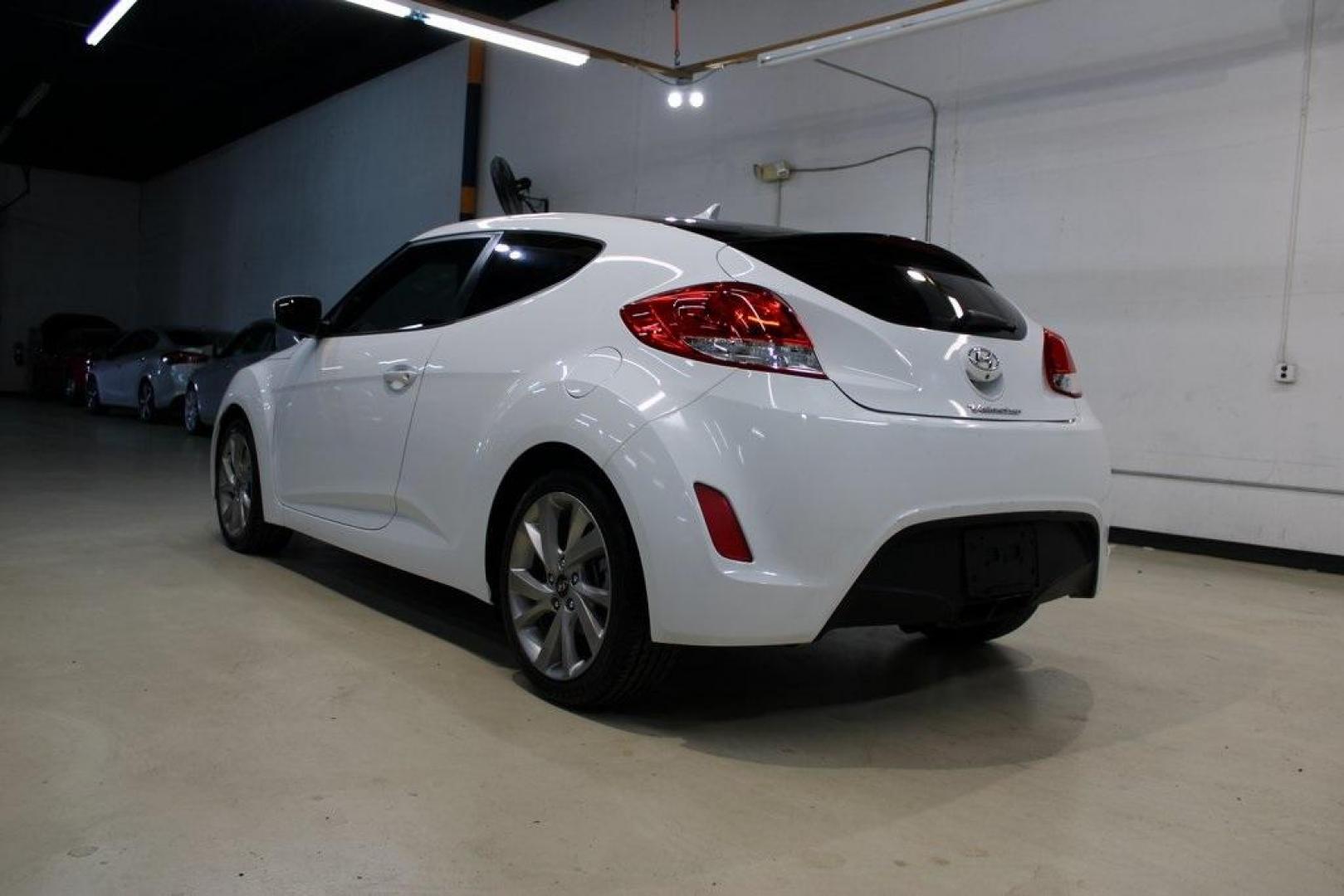 2016 White /Black Hyundai Veloster Base (KMHTC6AD8GU) with an 1.6L I4 DGI DOHC 16V ULEV II 132hp engine, Automatic transmission, located at 15300 Midway Rd., Addison, TX, 75001, (972) 702-0011, 32.958321, -96.838074 - 2016 Hyundai Veloster<br>Now Available at Midway Auto Group Addison, Texas<br><br>Sporty, unique, and fun to drive, the 2016 Hyundai Veloster stands out with its bold design and hatchback versatility. Perfect for drivers who want style, efficiency, and modern tech in one compact package, the Velost - Photo#3