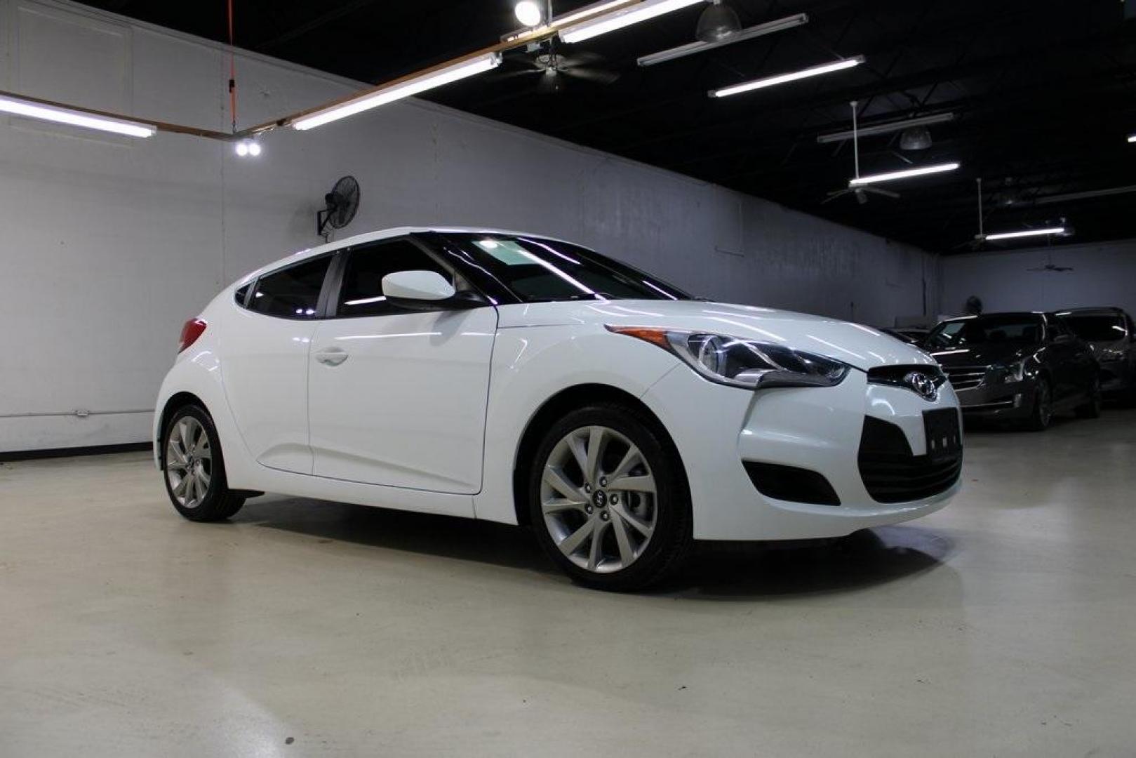 2016 White /Black Hyundai Veloster Base (KMHTC6AD8GU) with an 1.6L I4 DGI DOHC 16V ULEV II 132hp engine, Automatic transmission, located at 15300 Midway Rd., Addison, TX, 75001, (972) 702-0011, 32.958321, -96.838074 - 2016 Hyundai Veloster<br>Now Available at Midway Auto Group Addison, Texas<br><br>Sporty, unique, and fun to drive, the 2016 Hyundai Veloster stands out with its bold design and hatchback versatility. Perfect for drivers who want style, efficiency, and modern tech in one compact package, the Velost - Photo#6