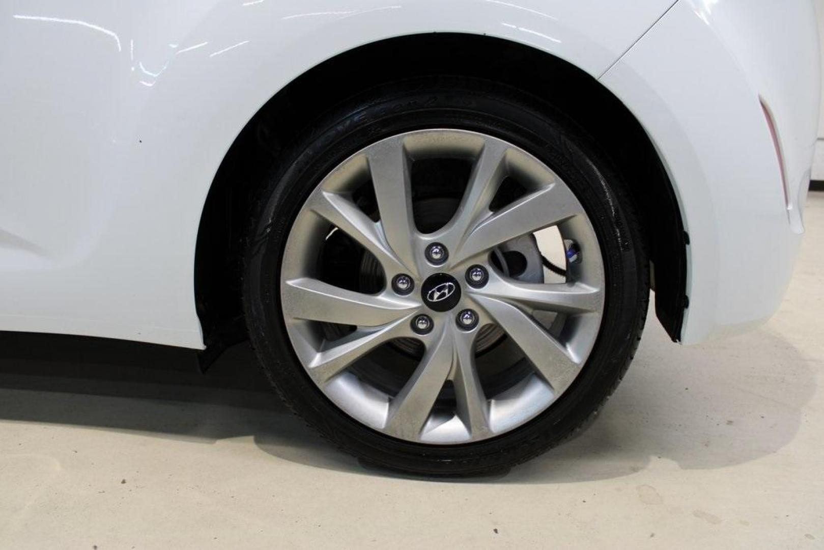 2016 White /Black Hyundai Veloster Base (KMHTC6AD8GU) with an 1.6L I4 DGI DOHC 16V ULEV II 132hp engine, Automatic transmission, located at 15300 Midway Rd., Addison, TX, 75001, (972) 702-0011, 32.958321, -96.838074 - 2016 Hyundai Veloster<br>Now Available at Midway Auto Group Addison, Texas<br><br>Sporty, unique, and fun to drive, the 2016 Hyundai Veloster stands out with its bold design and hatchback versatility. Perfect for drivers who want style, efficiency, and modern tech in one compact package, the Velost - Photo#9
