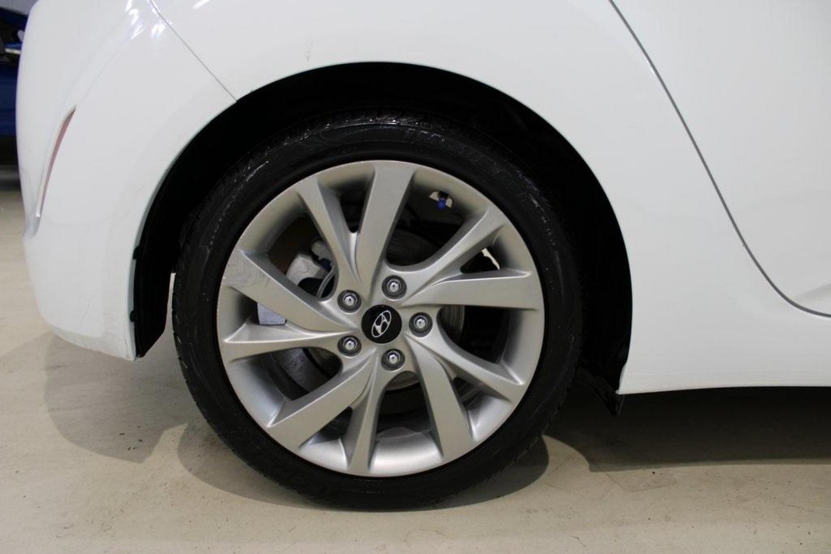 2016 White /Black Hyundai Veloster Base (KMHTC6AD8GU) with an 1.6L I4 DGI DOHC 16V ULEV II 132hp engine, Automatic transmission, located at 15300 Midway Rd., Addison, TX, 75001, (972) 702-0011, 32.958321, -96.838074 - 2016 Hyundai Veloster<br>Now Available at Midway Auto Group Addison, Texas<br><br>Sporty, unique, and fun to drive, the 2016 Hyundai Veloster stands out with its bold design and hatchback versatility. Perfect for drivers who want style, efficiency, and modern tech in one compact package, the Velost - Photo#10