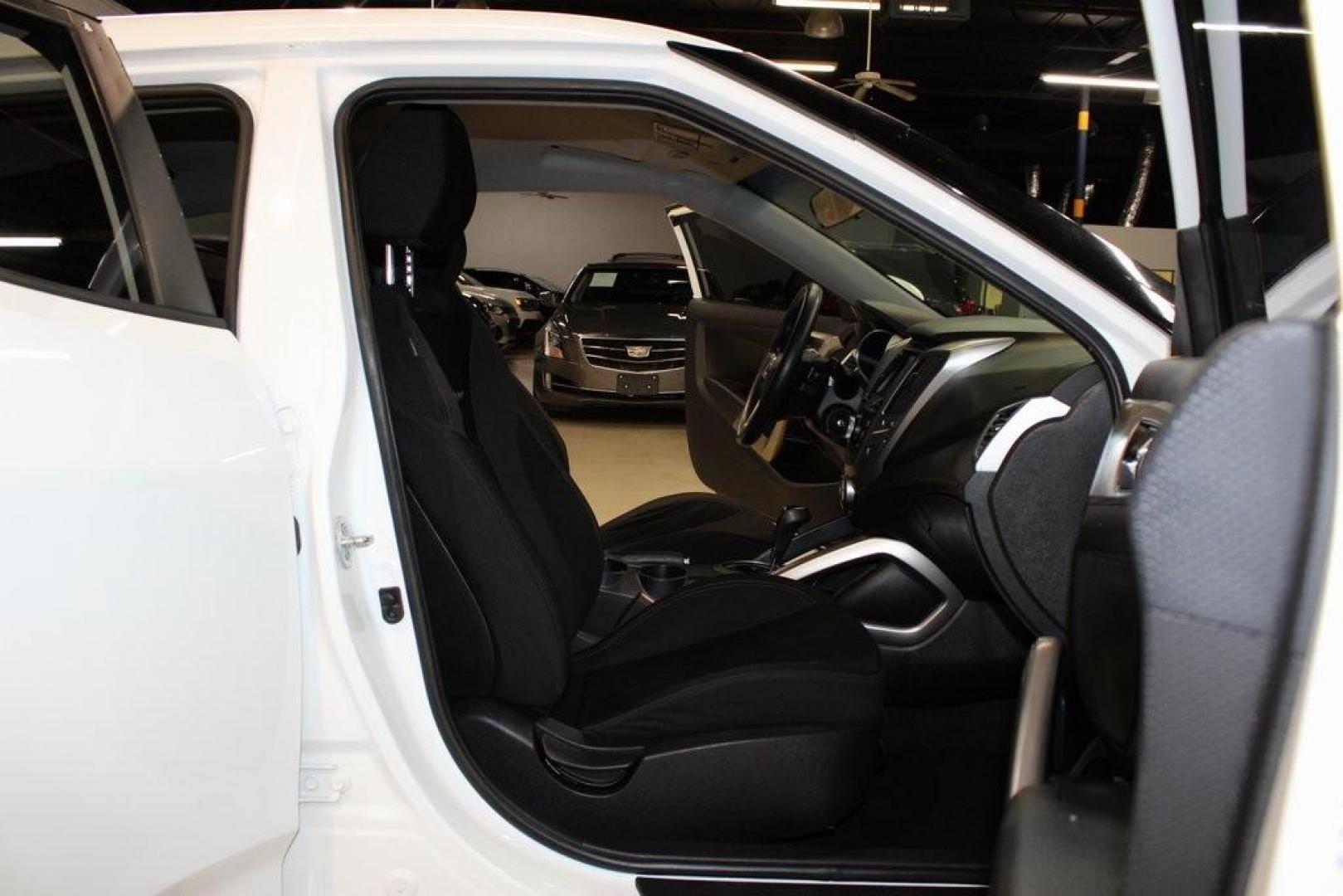 2016 White /Black Hyundai Veloster Base (KMHTC6AD8GU) with an 1.6L I4 DGI DOHC 16V ULEV II 132hp engine, Automatic transmission, located at 15300 Midway Rd., Addison, TX, 75001, (972) 702-0011, 32.958321, -96.838074 - 2016 Hyundai Veloster<br>Now Available at Midway Auto Group Addison, Texas<br><br>Sporty, unique, and fun to drive, the 2016 Hyundai Veloster stands out with its bold design and hatchback versatility. Perfect for drivers who want style, efficiency, and modern tech in one compact package, the Velost - Photo#14
