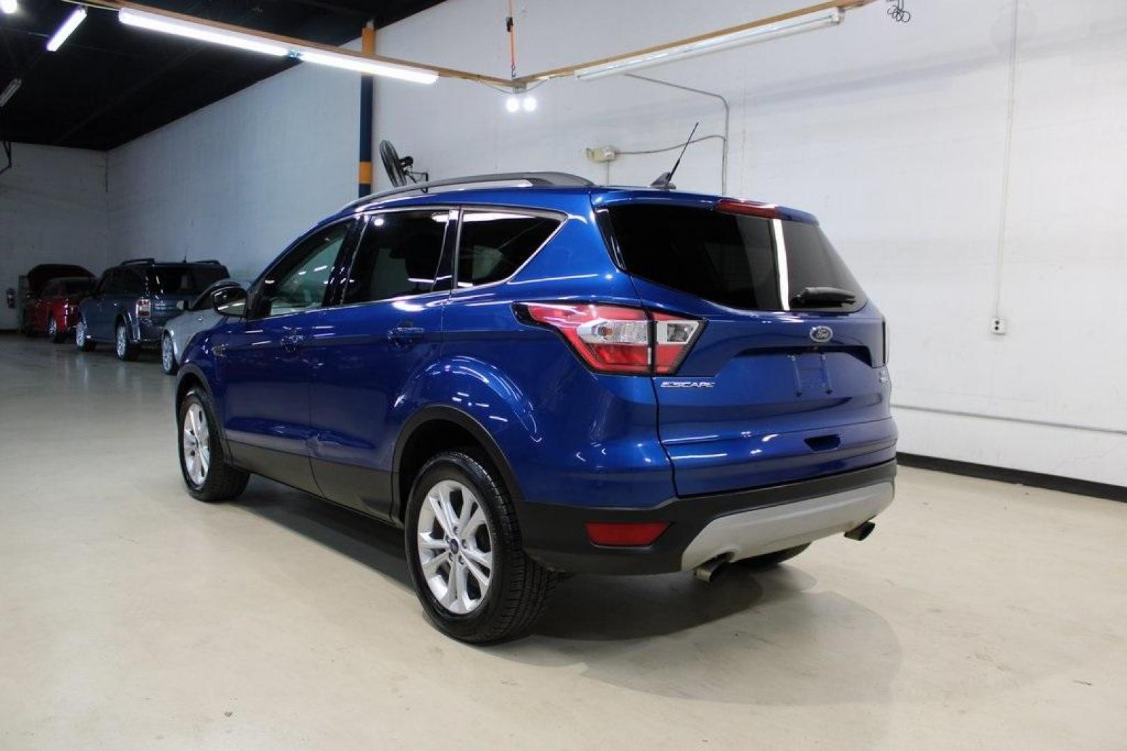 2018 Lightning Blue /Charcoal Black Ford Escape SE (1FMCU9GD6JU) with an EcoBoost 2.0L I4 GTDi DOHC Turbocharged VCT engine, Automatic transmission, located at 15300 Midway Rd., Addison, TX, 75001, (972) 702-0011, 32.958321, -96.838074 - 2018 Ford Escape SE<br>Now Available at Midway Auto Group Addison, Texas<br><br>Stylish, versatile, and packed with features, the 2018 Ford Escape SE offers a confident driving experience thats perfect for both urban commutes and weekend getaways. With its turbocharged performance, smart technology - Photo#3